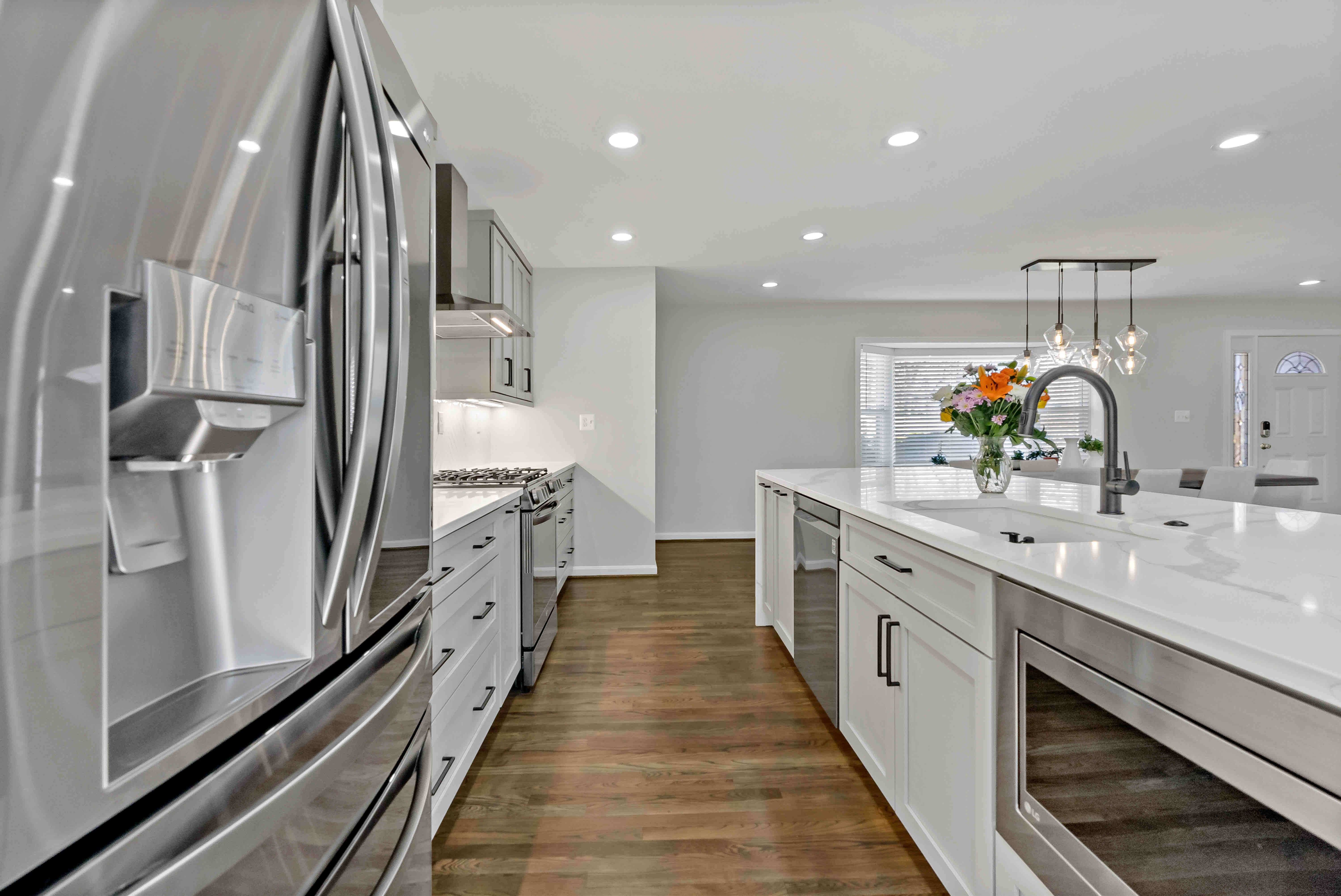 White kitchen with silver appliances and fixtures