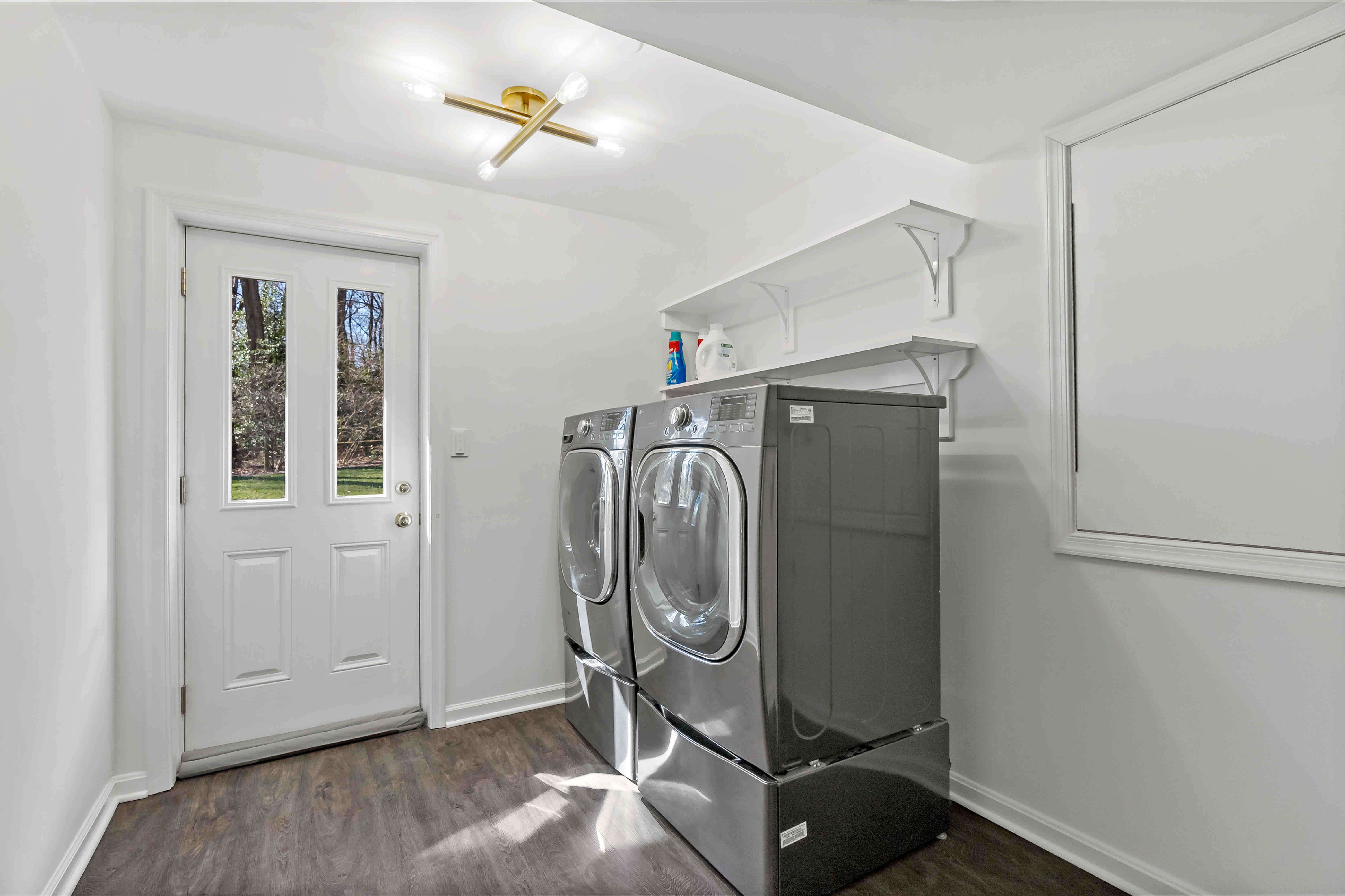 Laundry room with hard wood floors