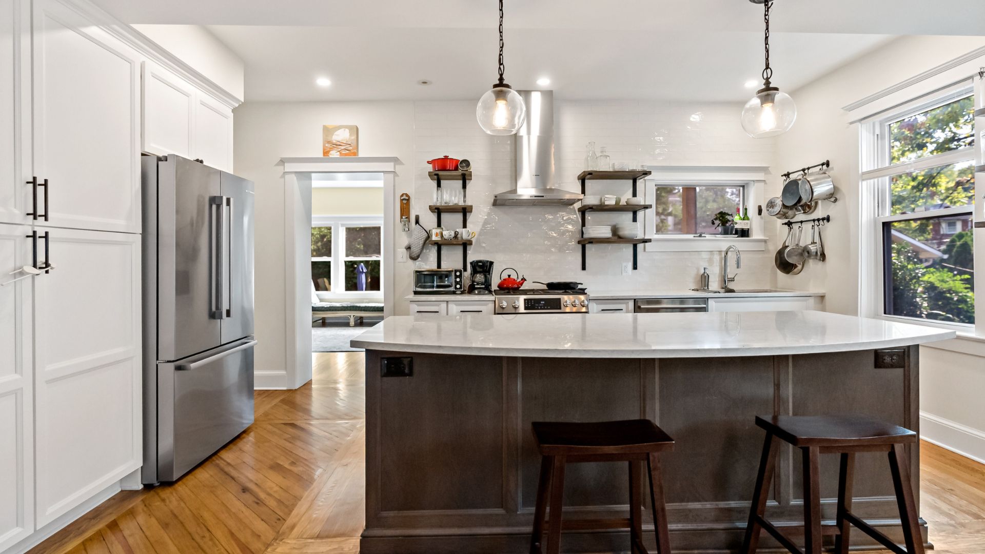 Brown floating shelves and white cabinets in kitchen