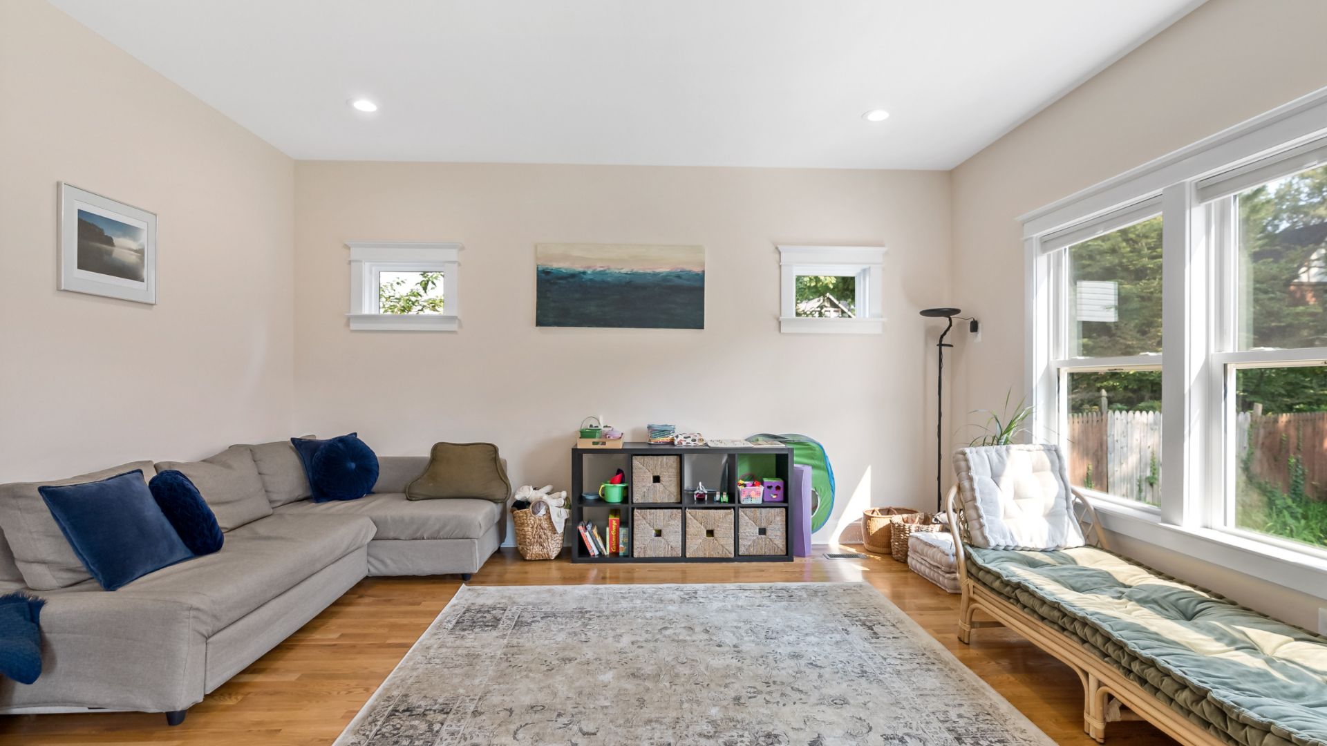 Sitting area with large windows overlooking backyard