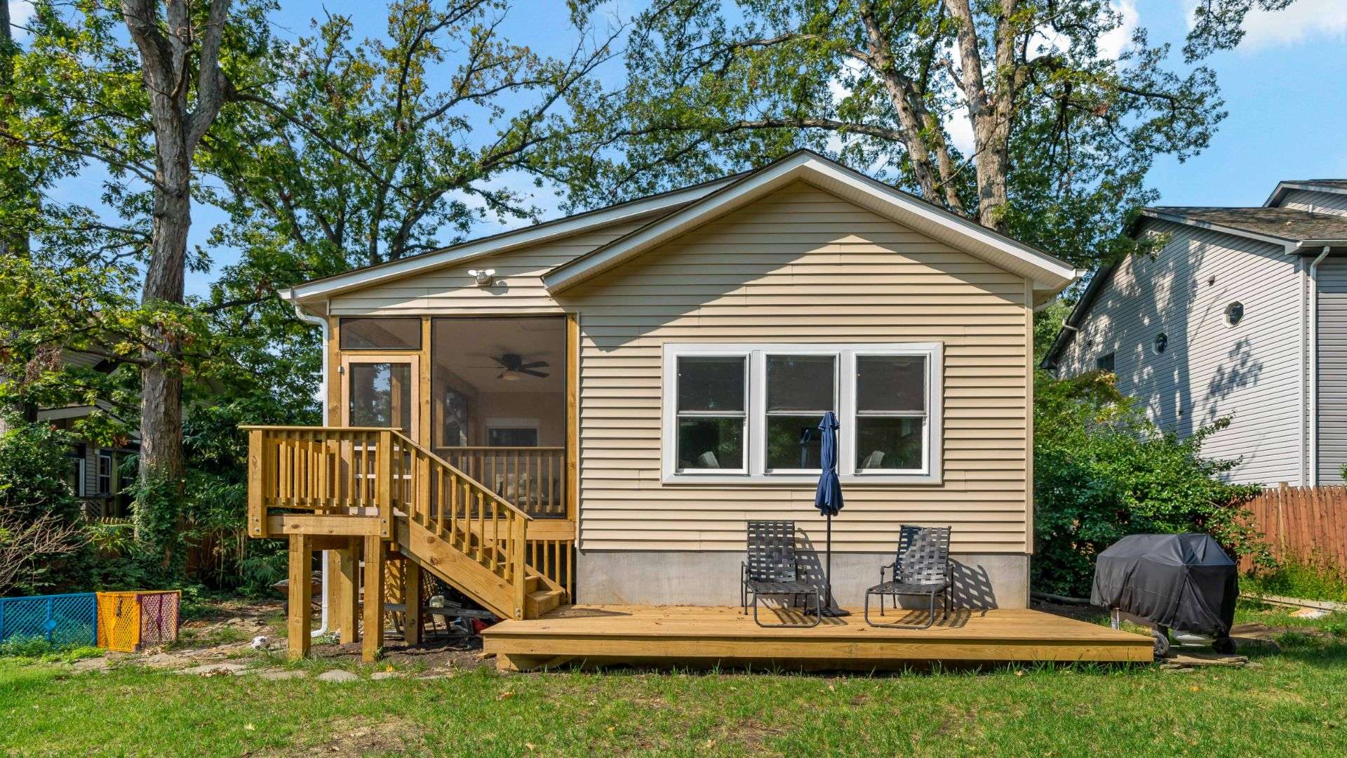 Exterior back of home with screened porch and patio