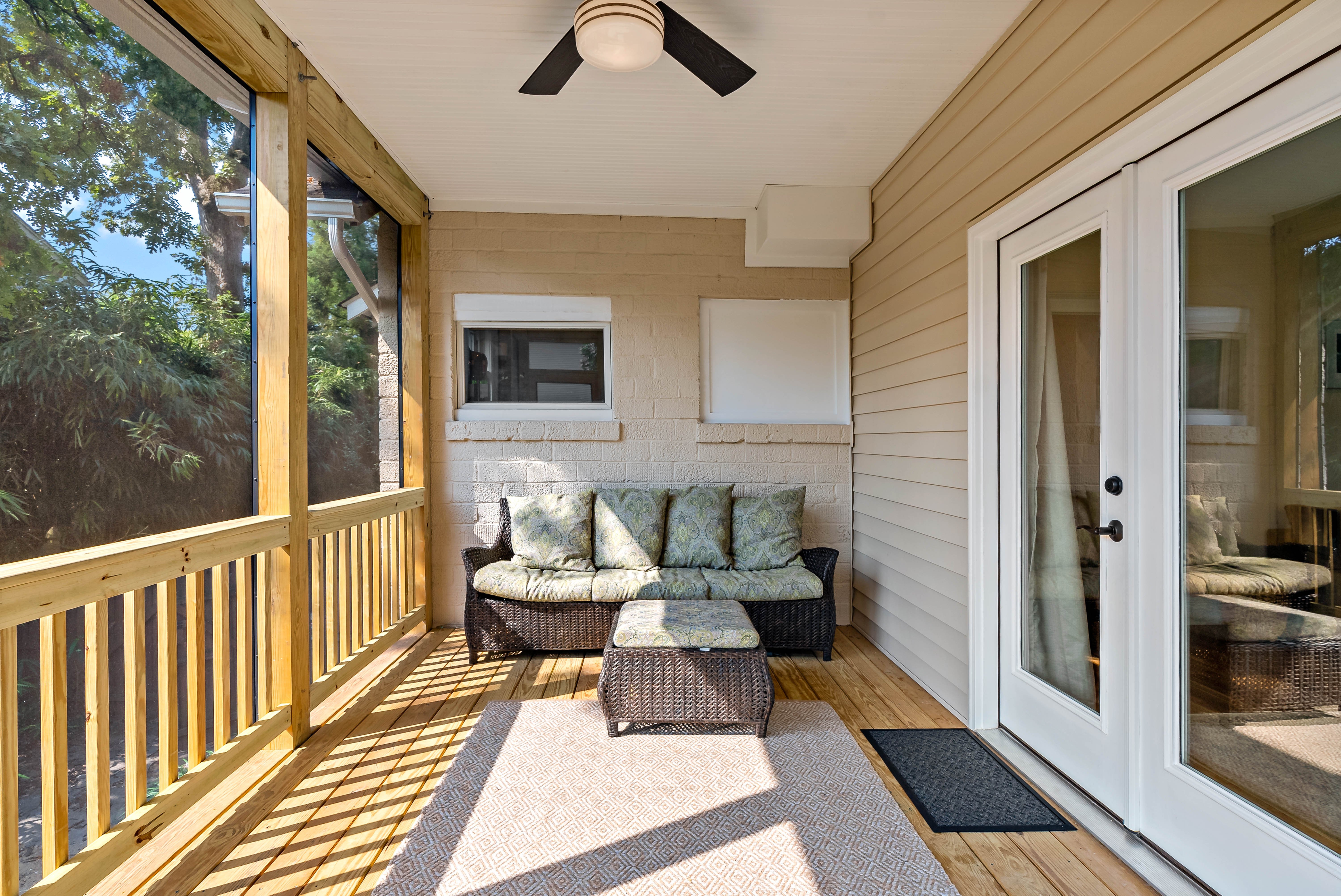 Ceiling fan and patio furniture in screened porch