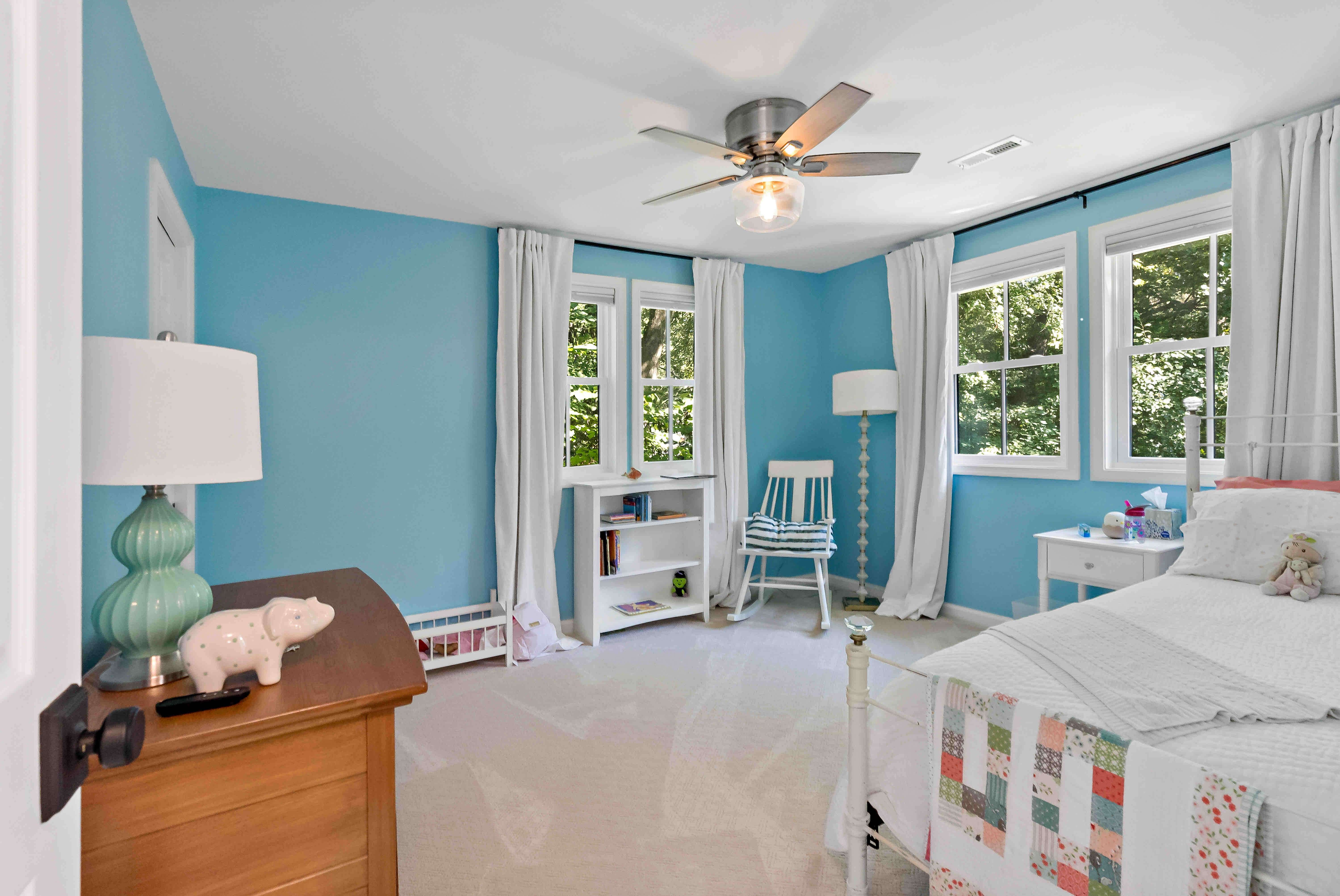 Bedroom with blue walls and white ceiling