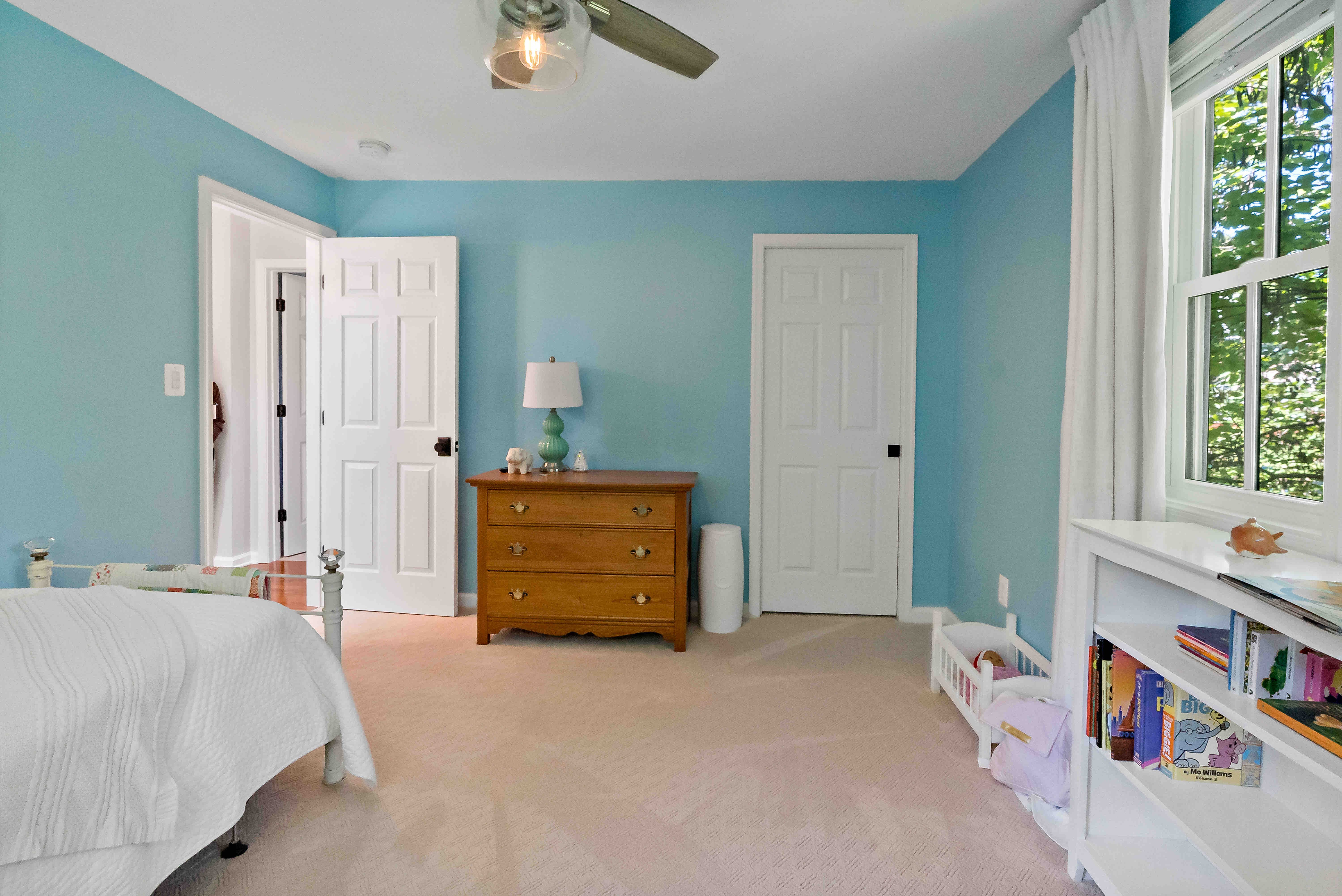 Blue walls in bedroom with ceiling fan