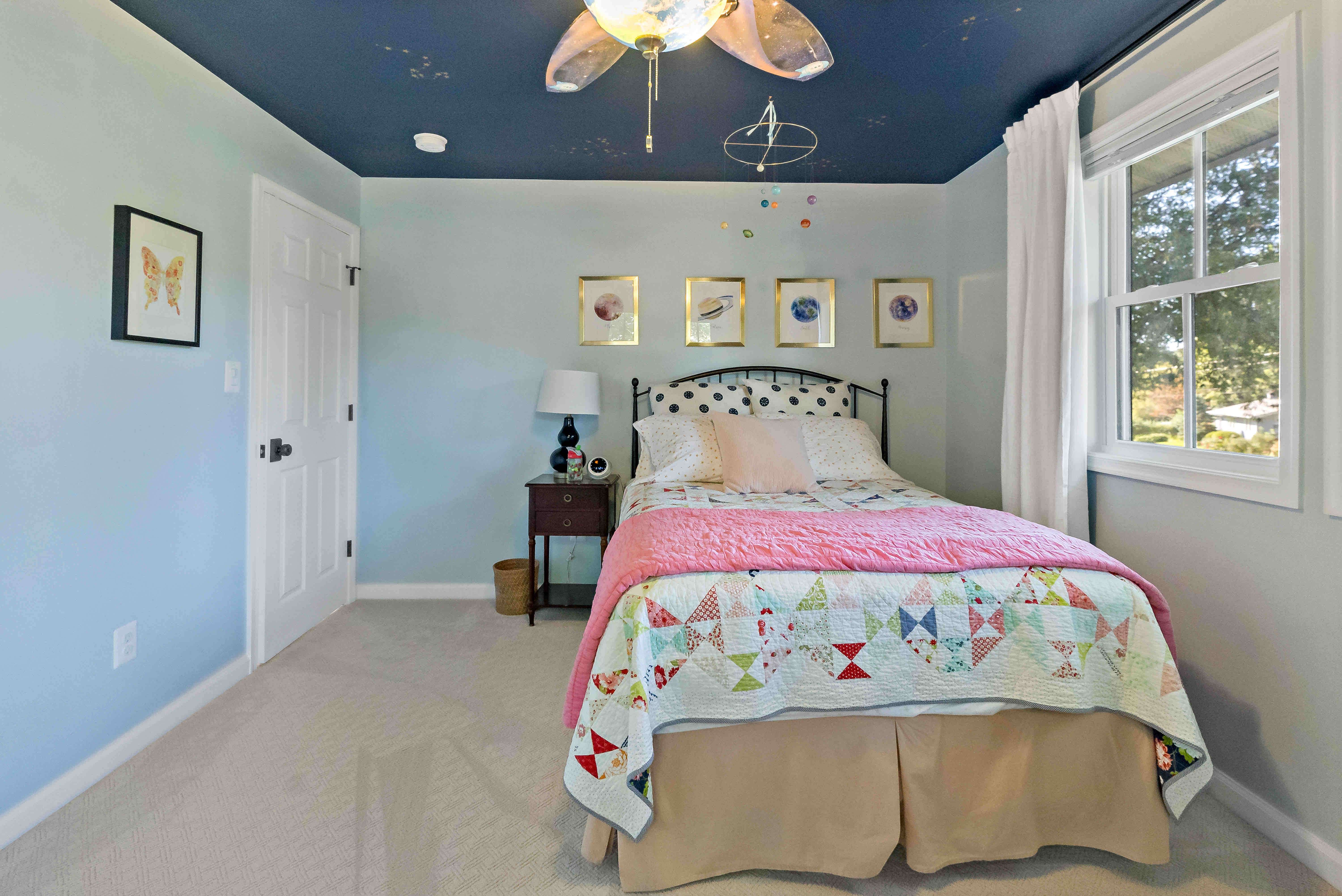 Girls bedroom with ceiling fan and blue ceiling