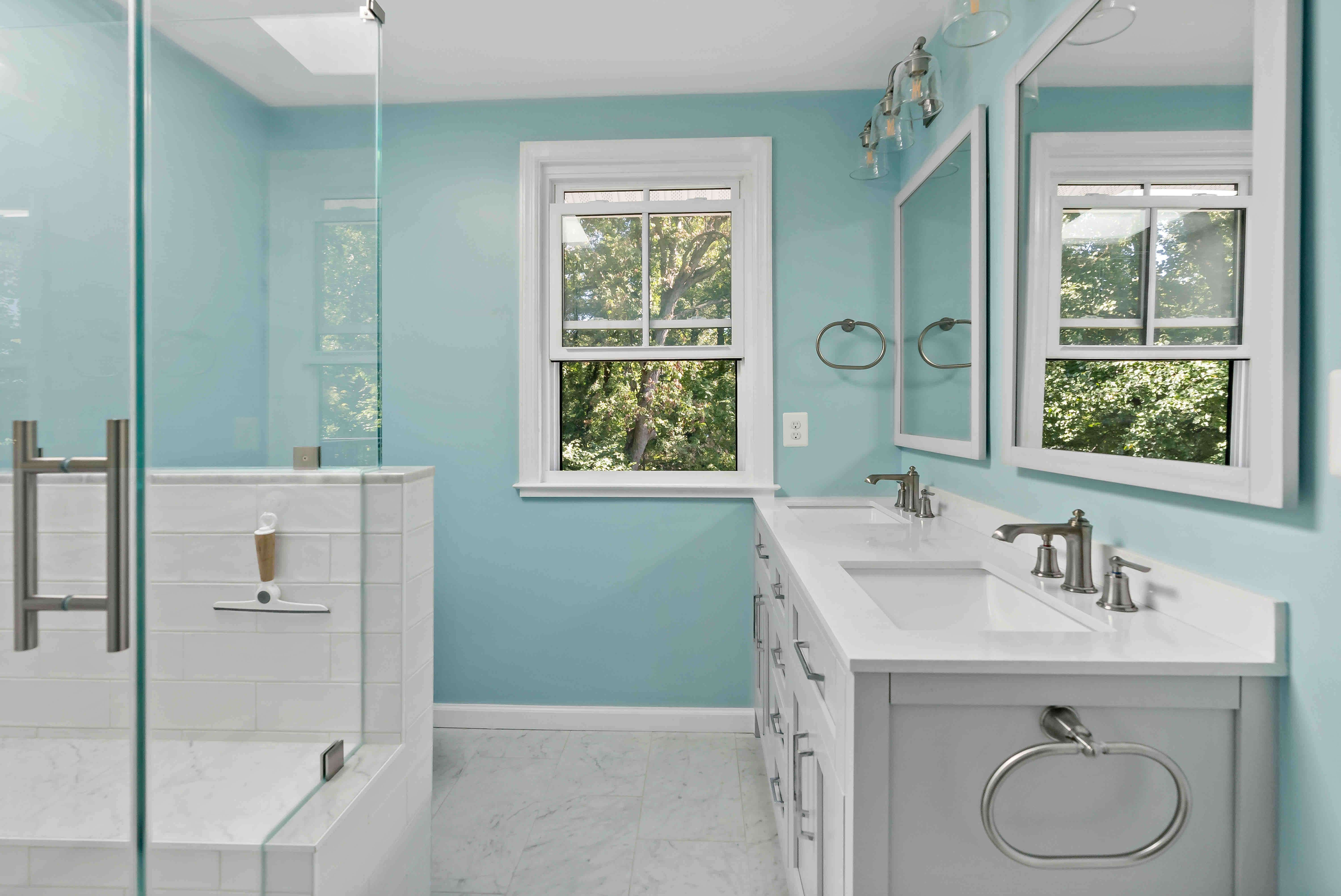 Bathroom with blue walls and glass shower