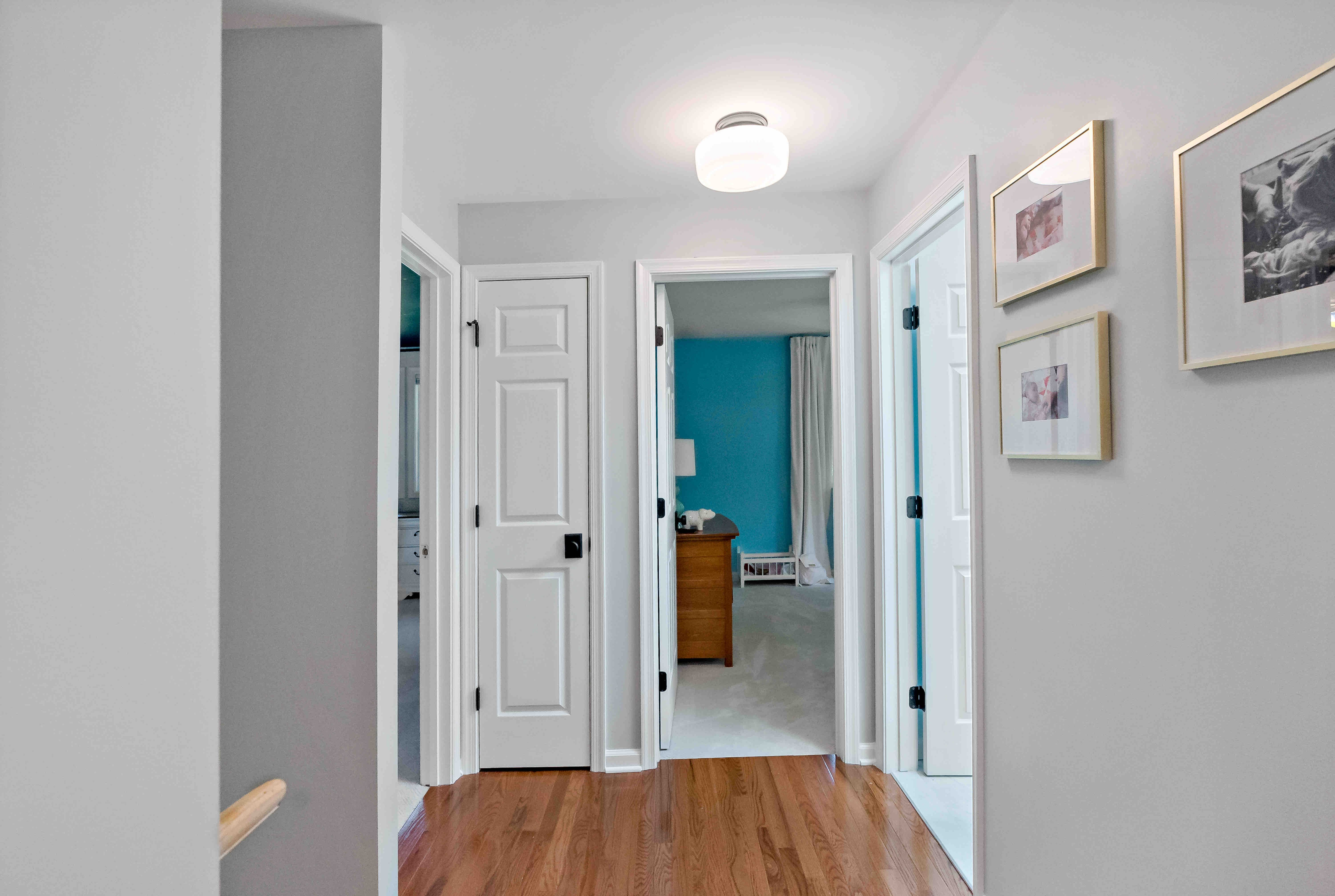 Hard wood floor hallway leading to bedroom
