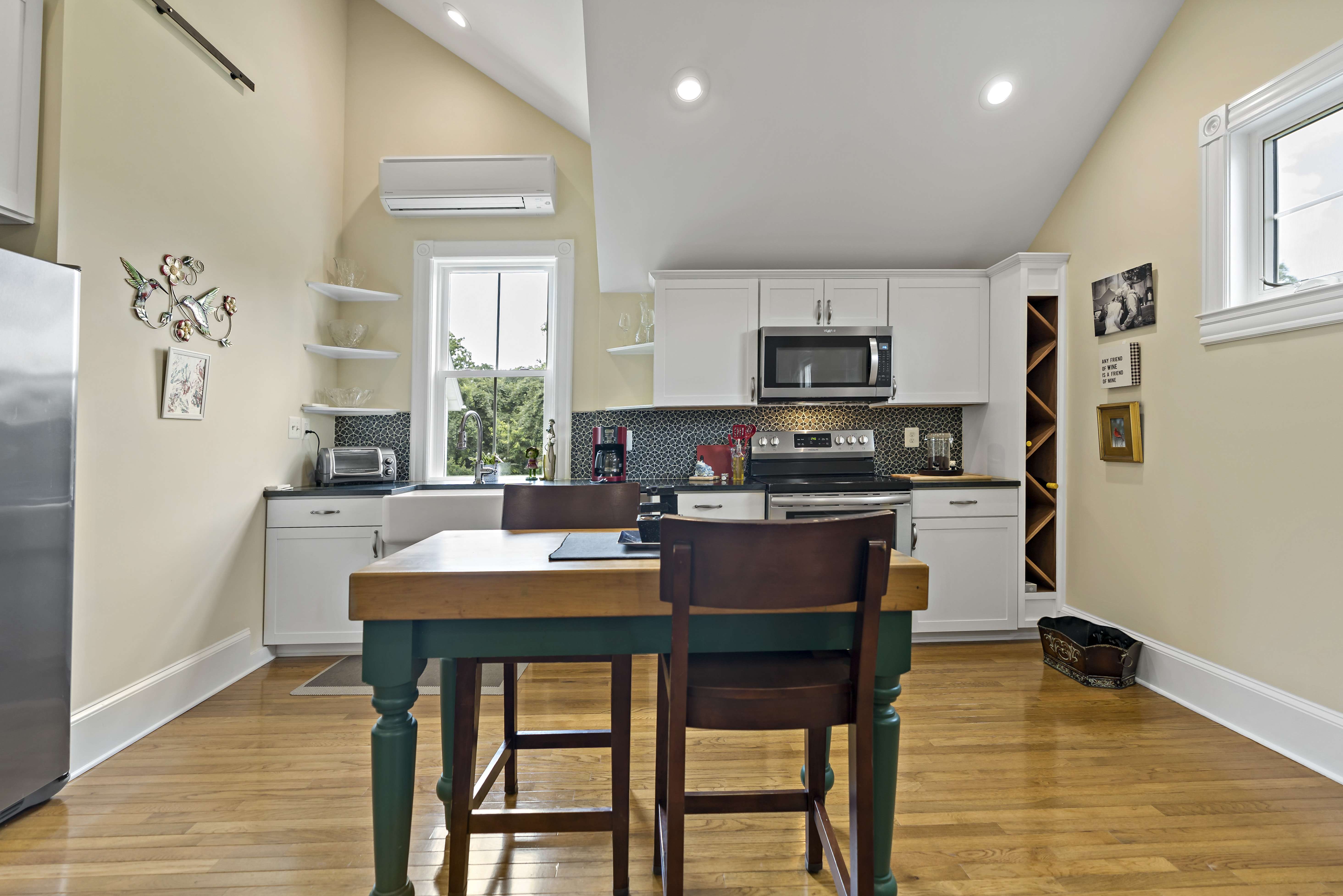 Kitchen with hard wood floors and uneven ceiling