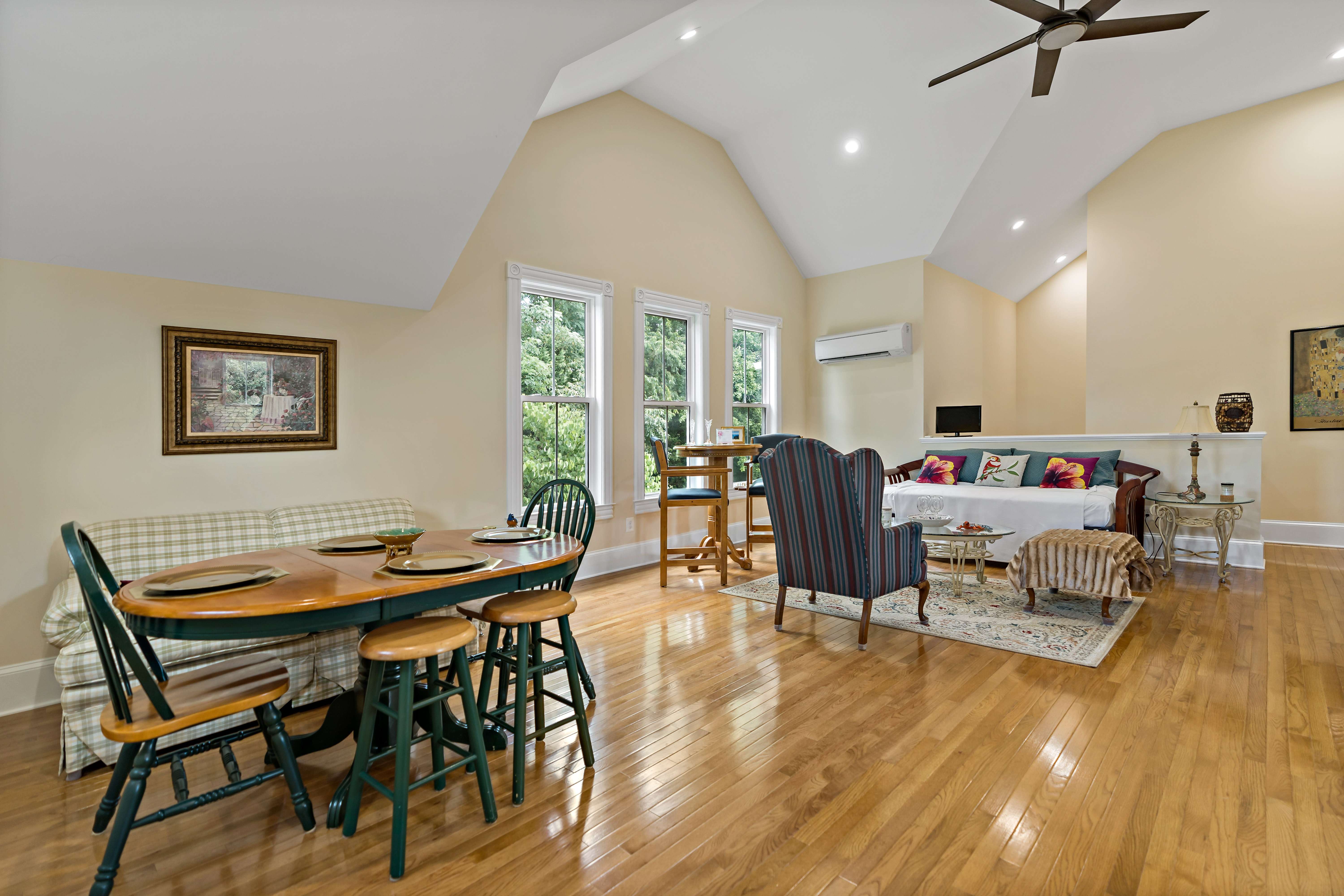 Unique uneven shaped ceiling with ceiling fan and hard wood floor in kitchen area