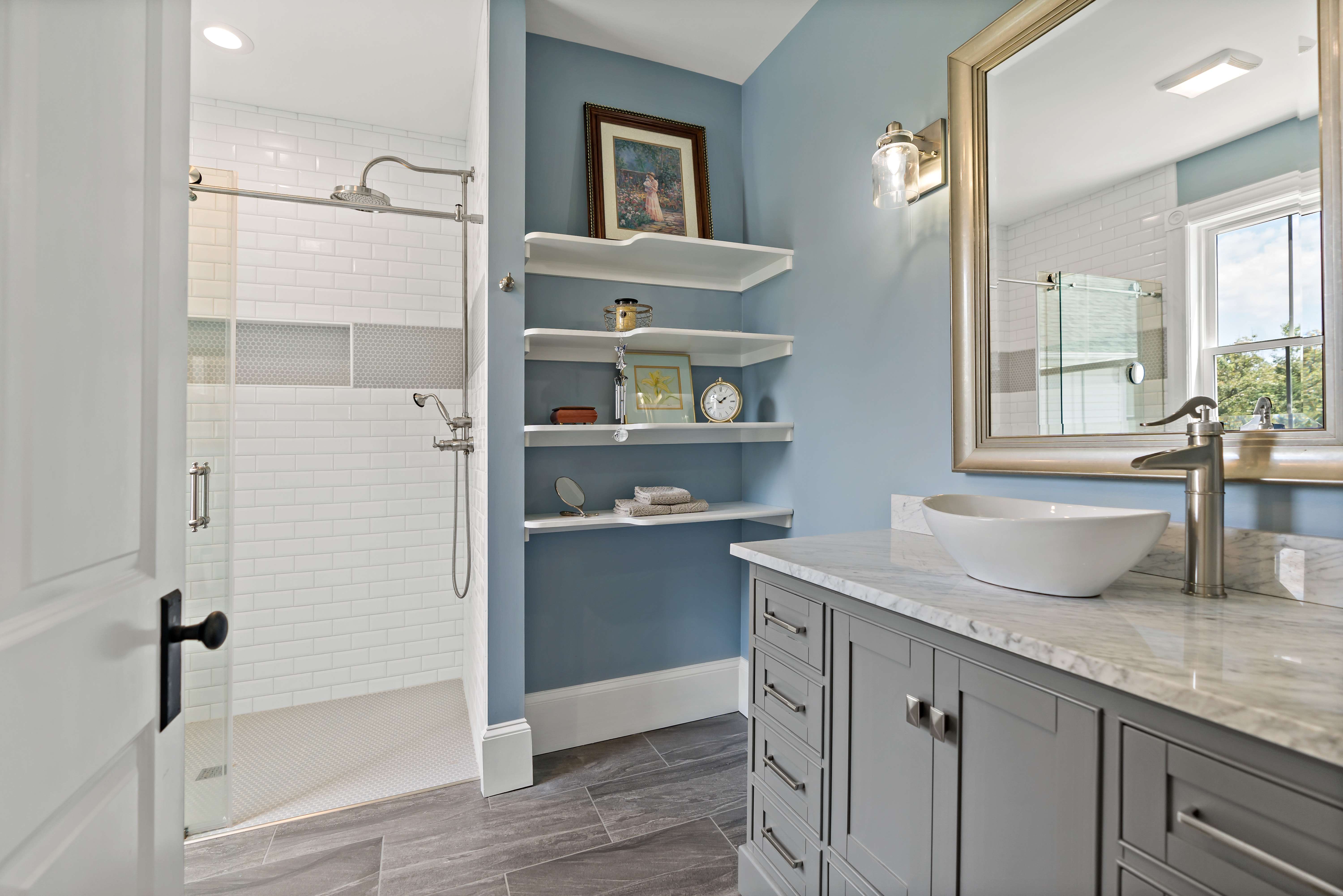 Blue wall bathroom with stand up shower