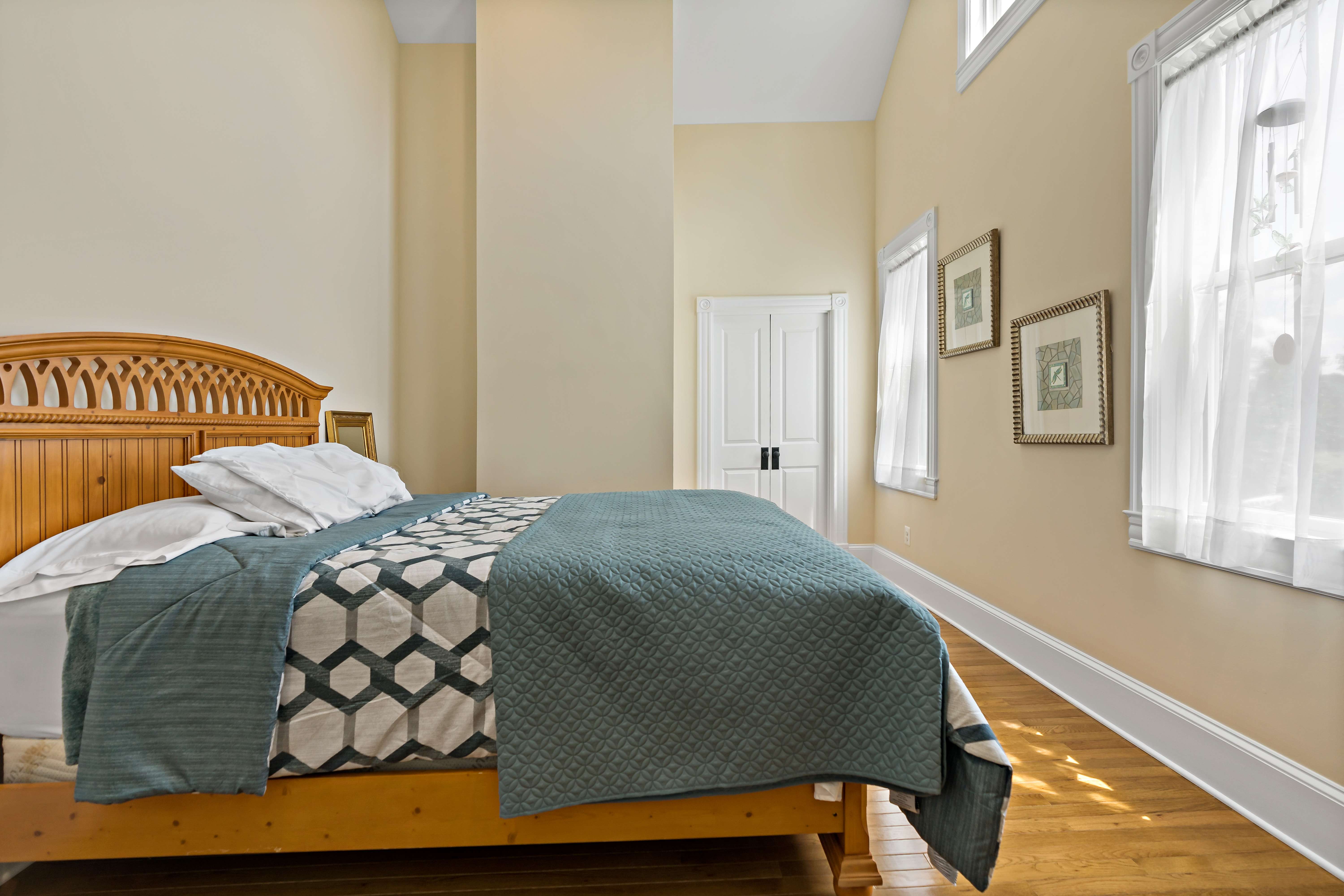 Small bedroom with hard wood floors and white trim
