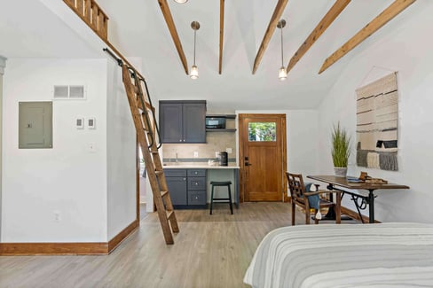 Mini wet bar kitchenette with exposed wood beams on ceiling