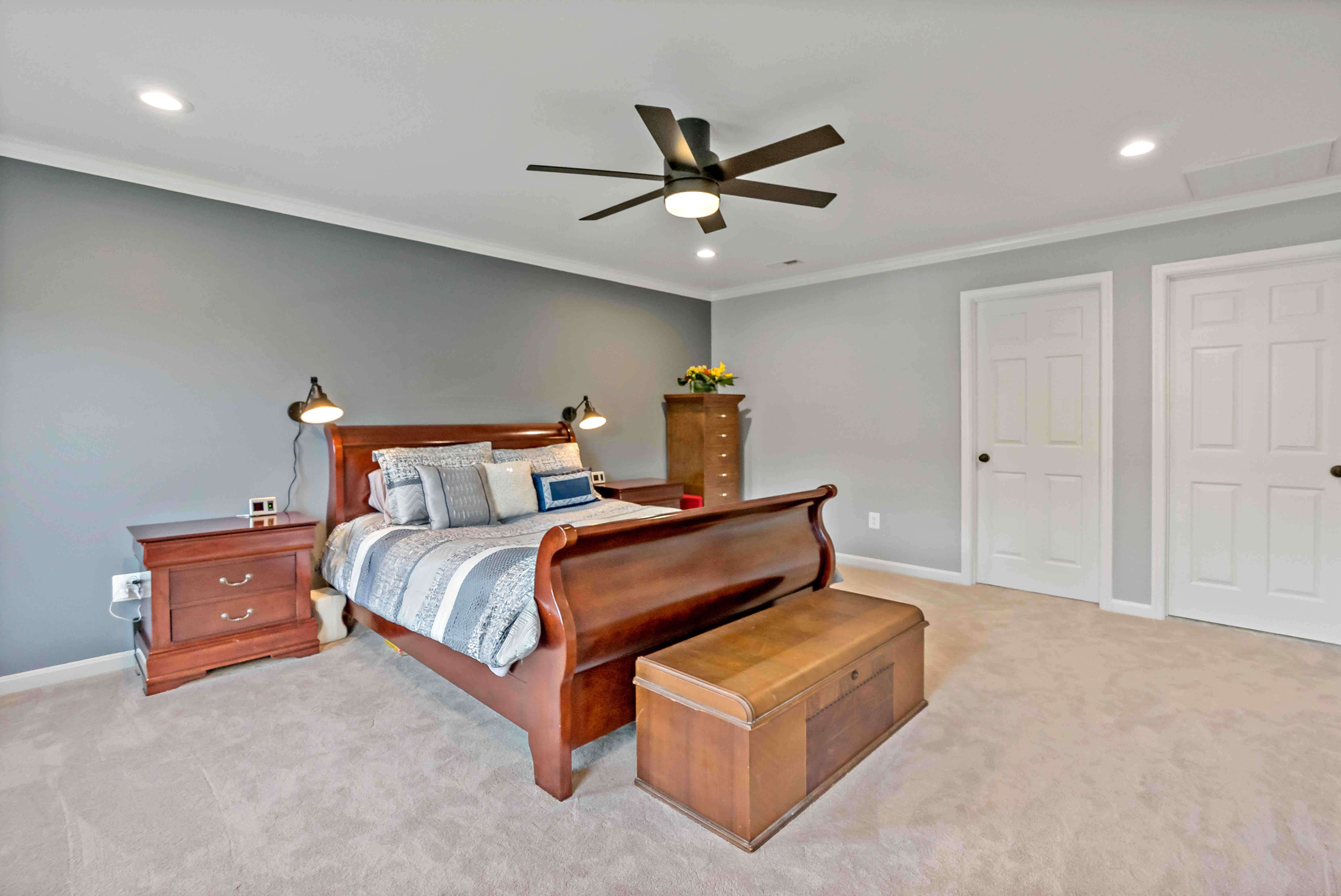 Bedroom with beige carpet and ceiling fan
