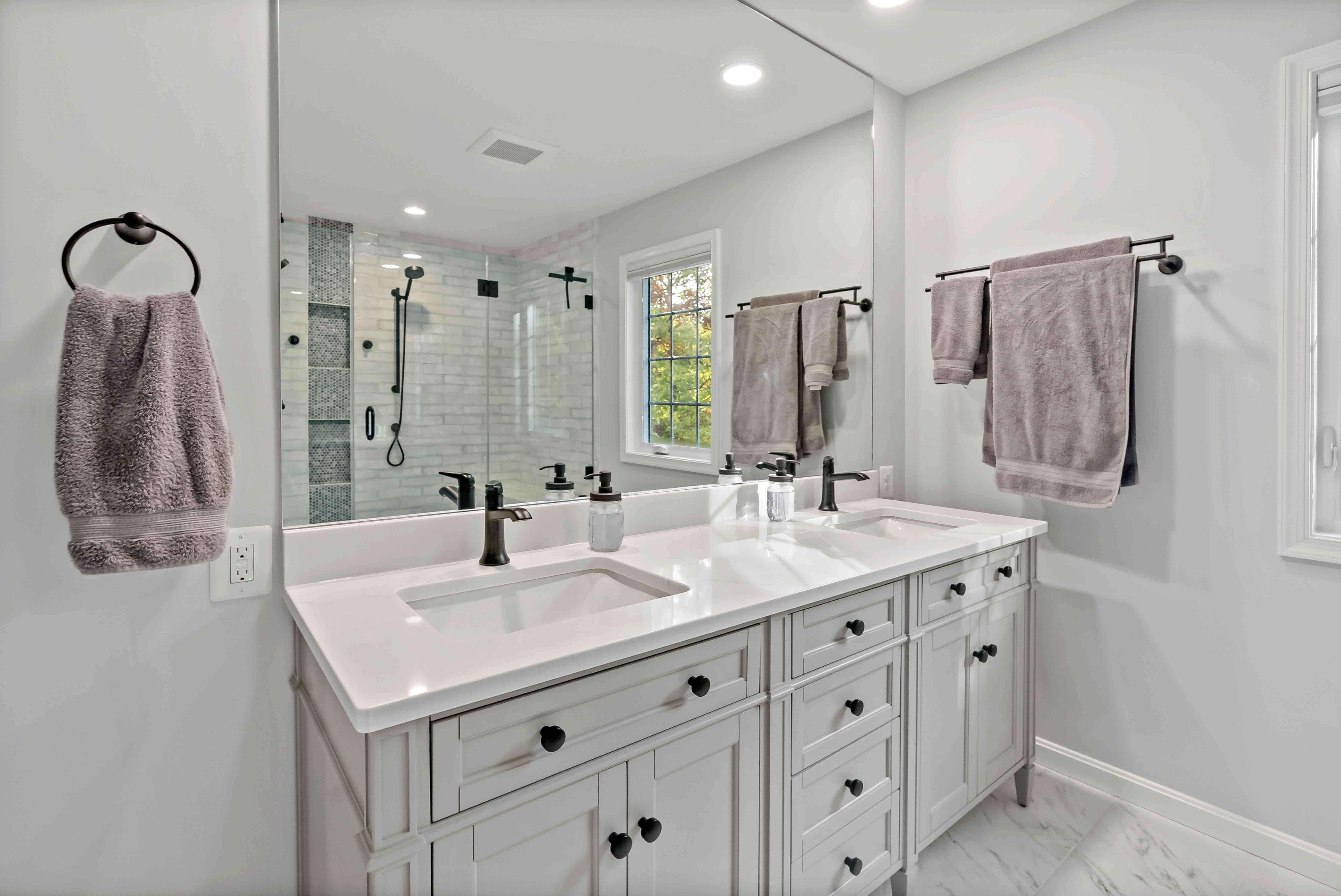 Double sink white bathroom with large mirror
