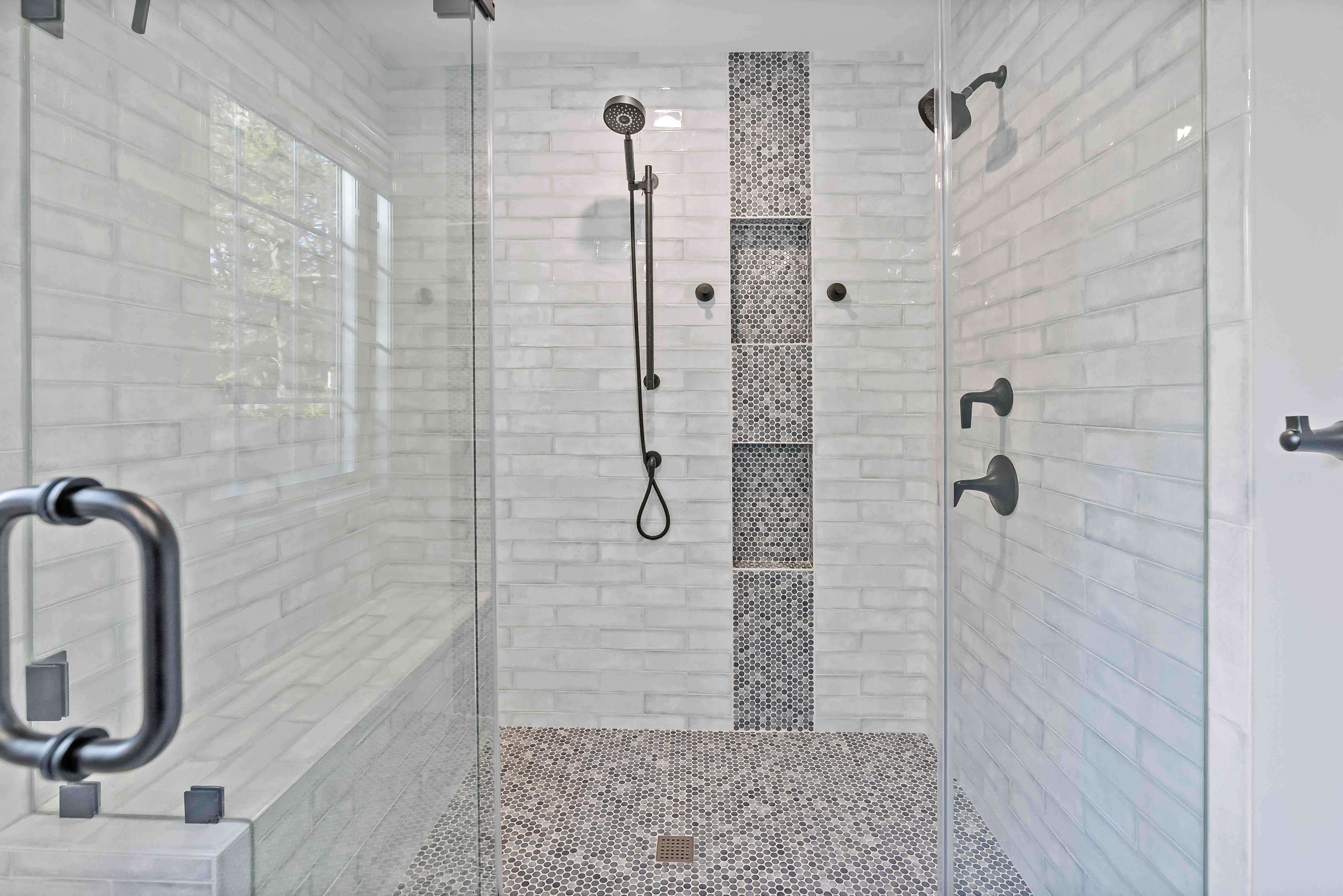 Walk in glass shower with black fixtures