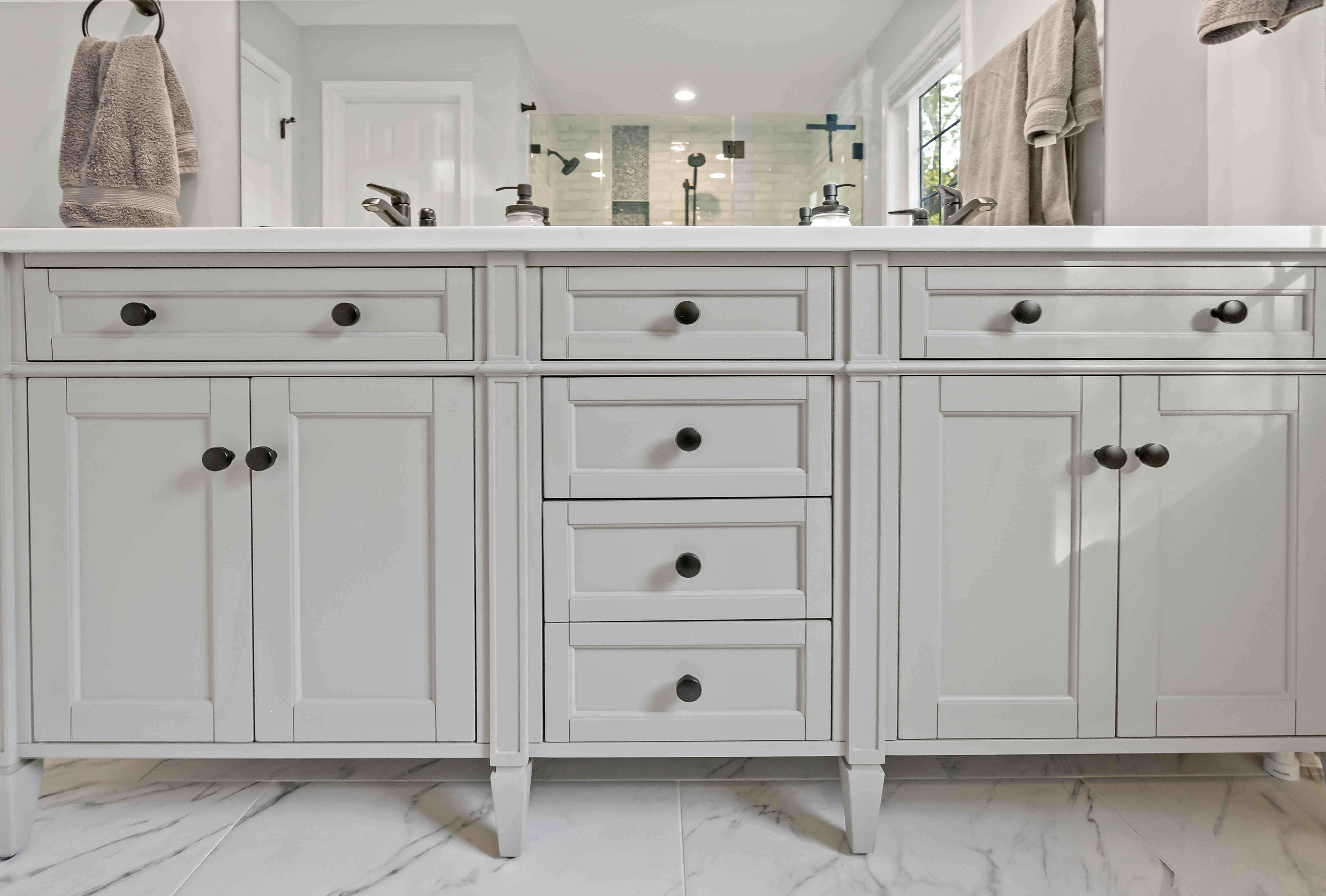 Double sink and white cabinetry in bathroom