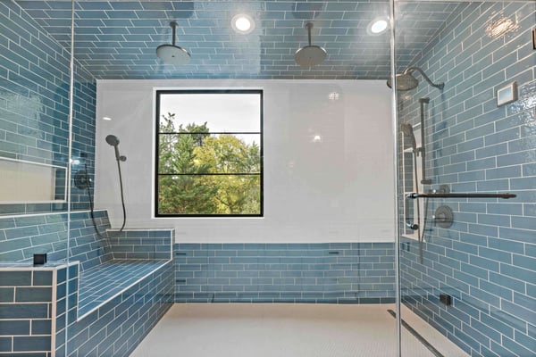 Blue rectangle tile in large walk-in shower with bench