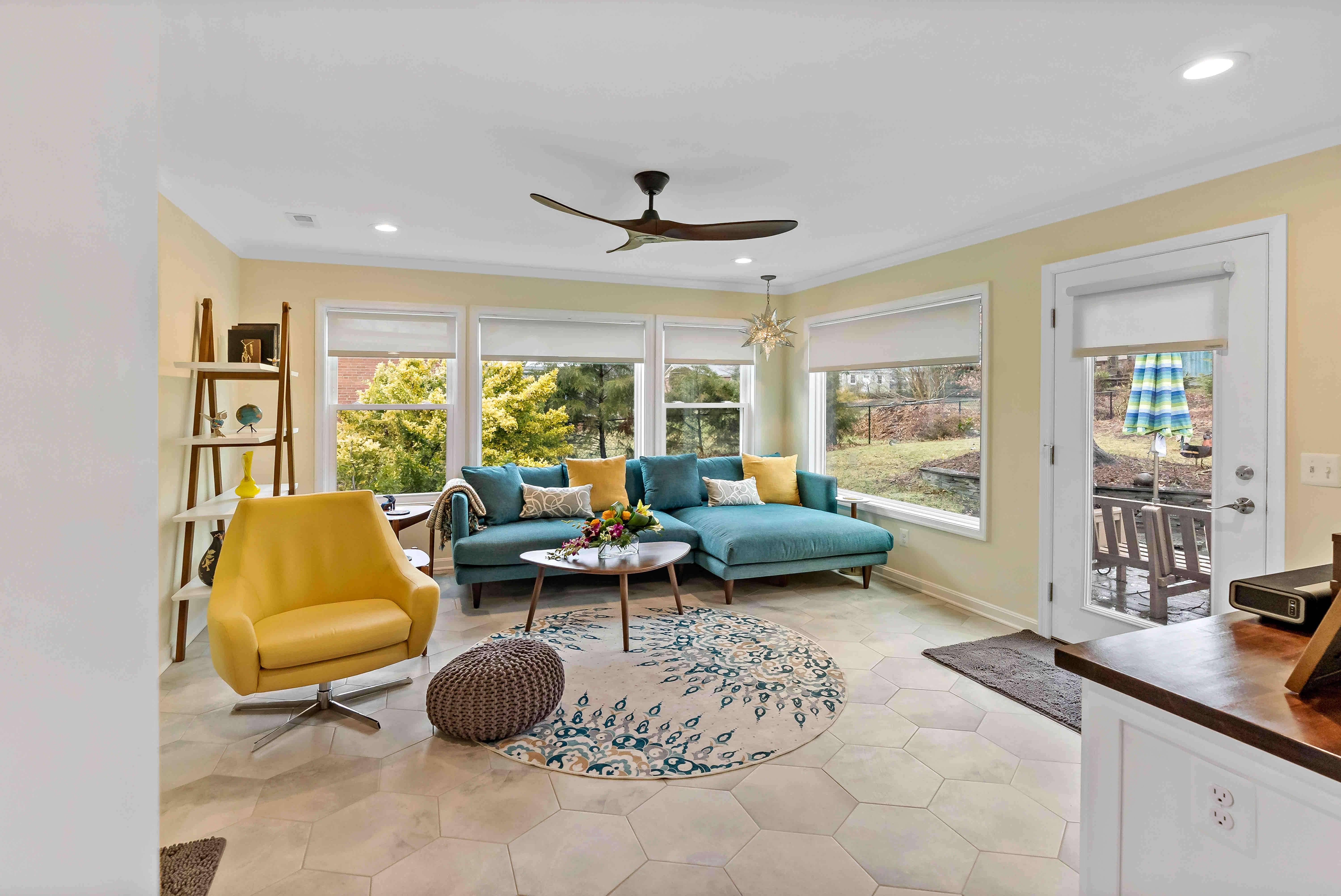 Large windows and ceiling fan in sitting area