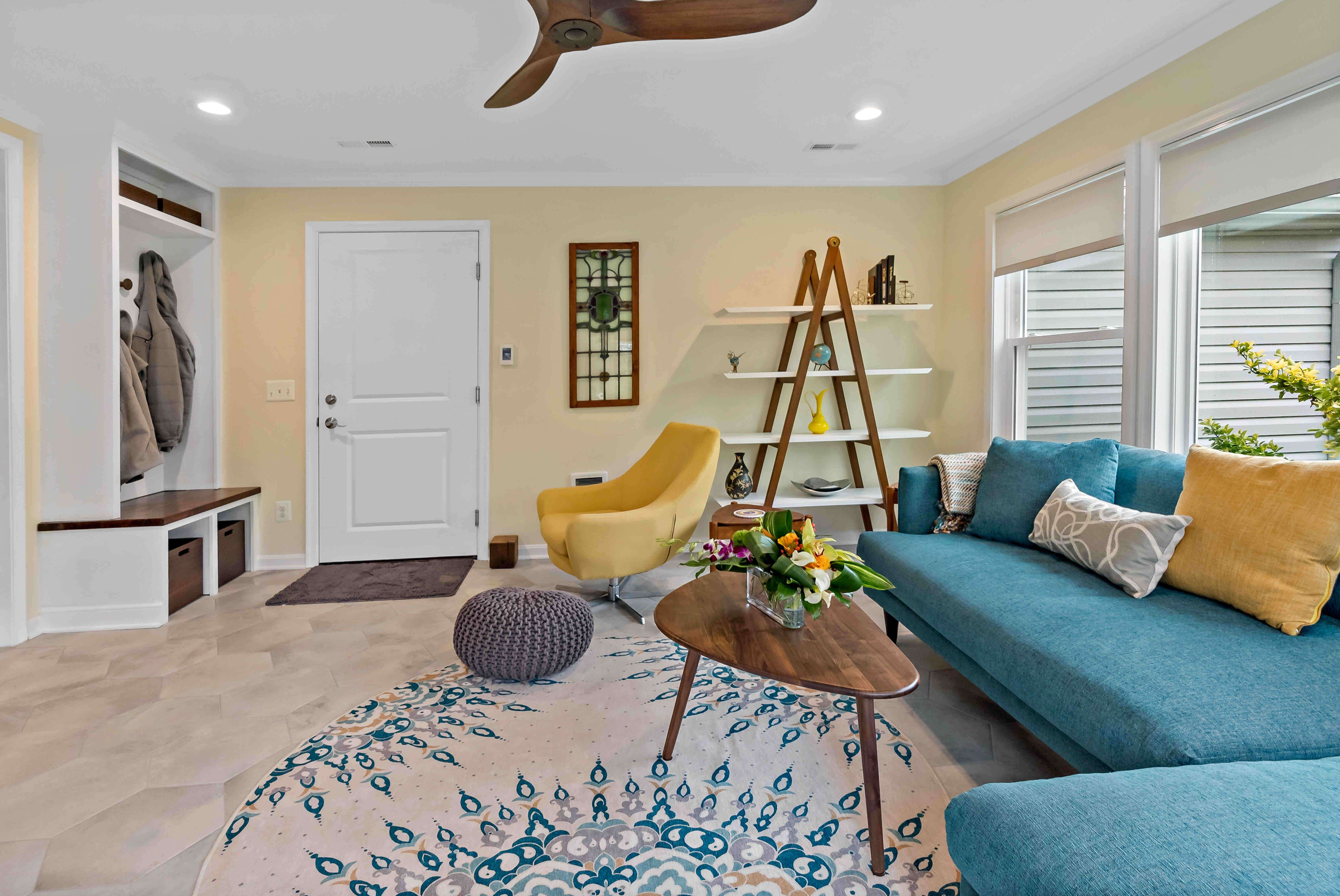 Carpeted room with circular rug underneath couch