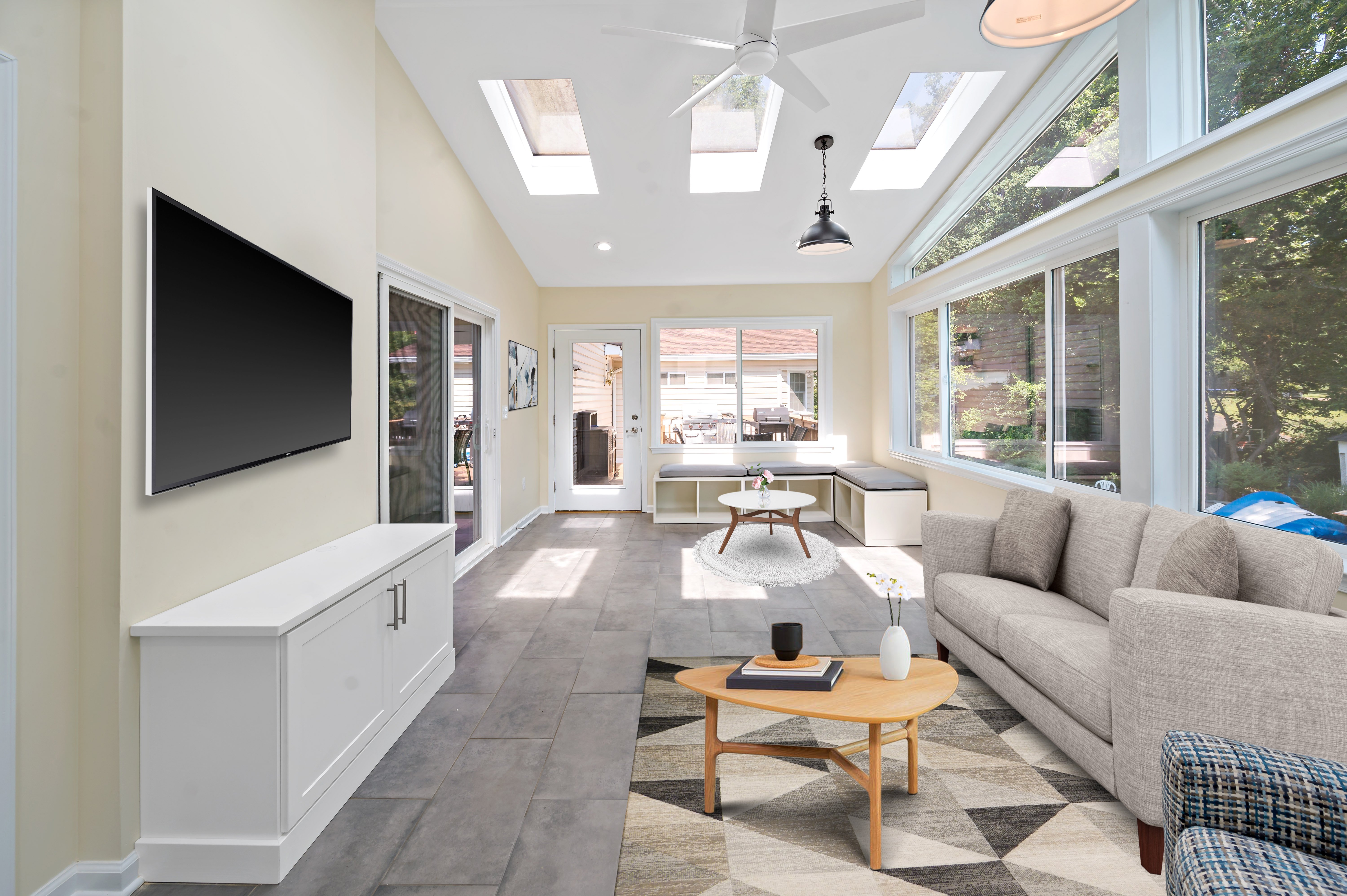 Large windows and couches in sunroom