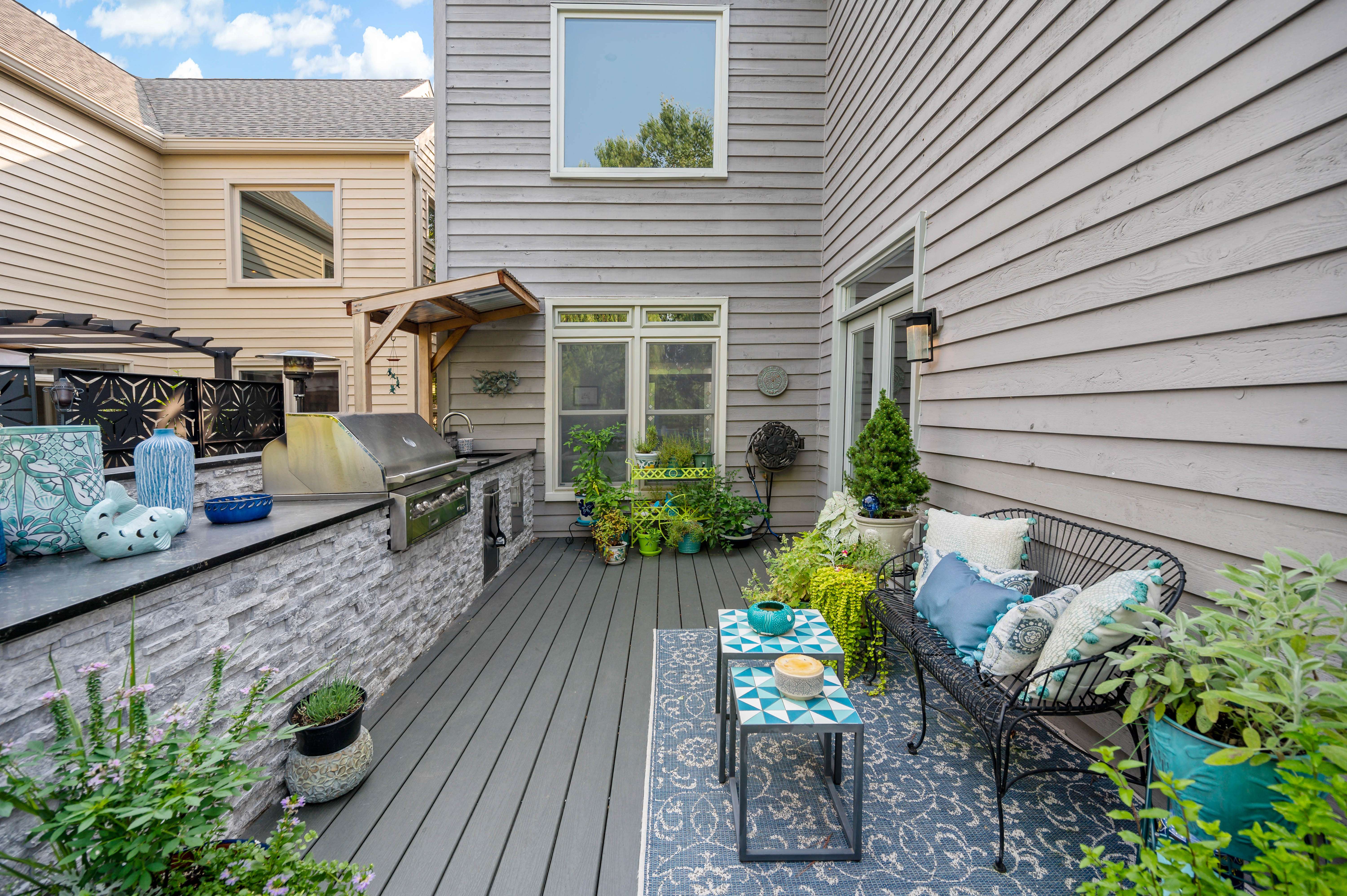 Grey paneling on house and matching flooring on deck