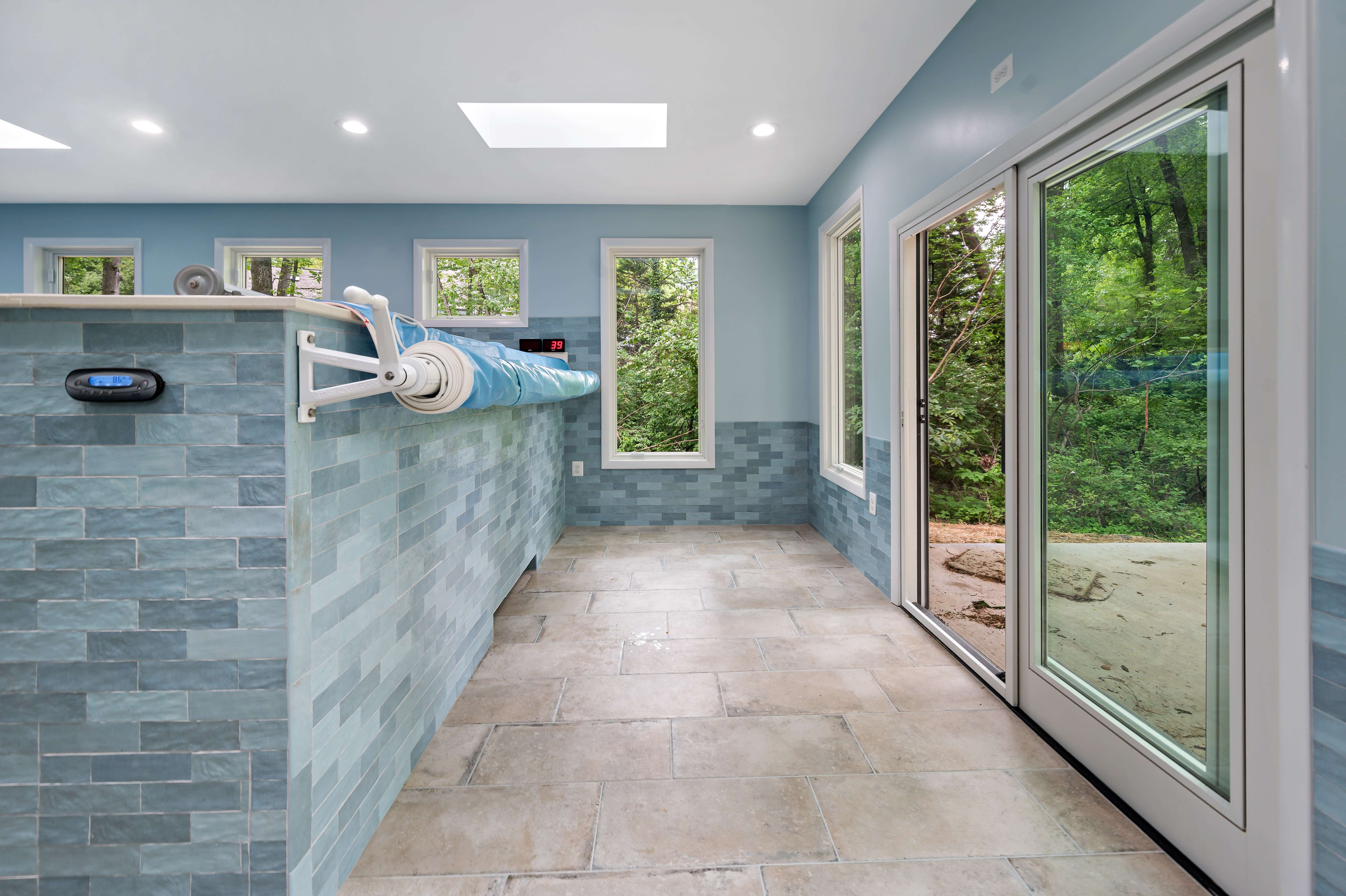 Indoor Pool with sliding door access to backyard