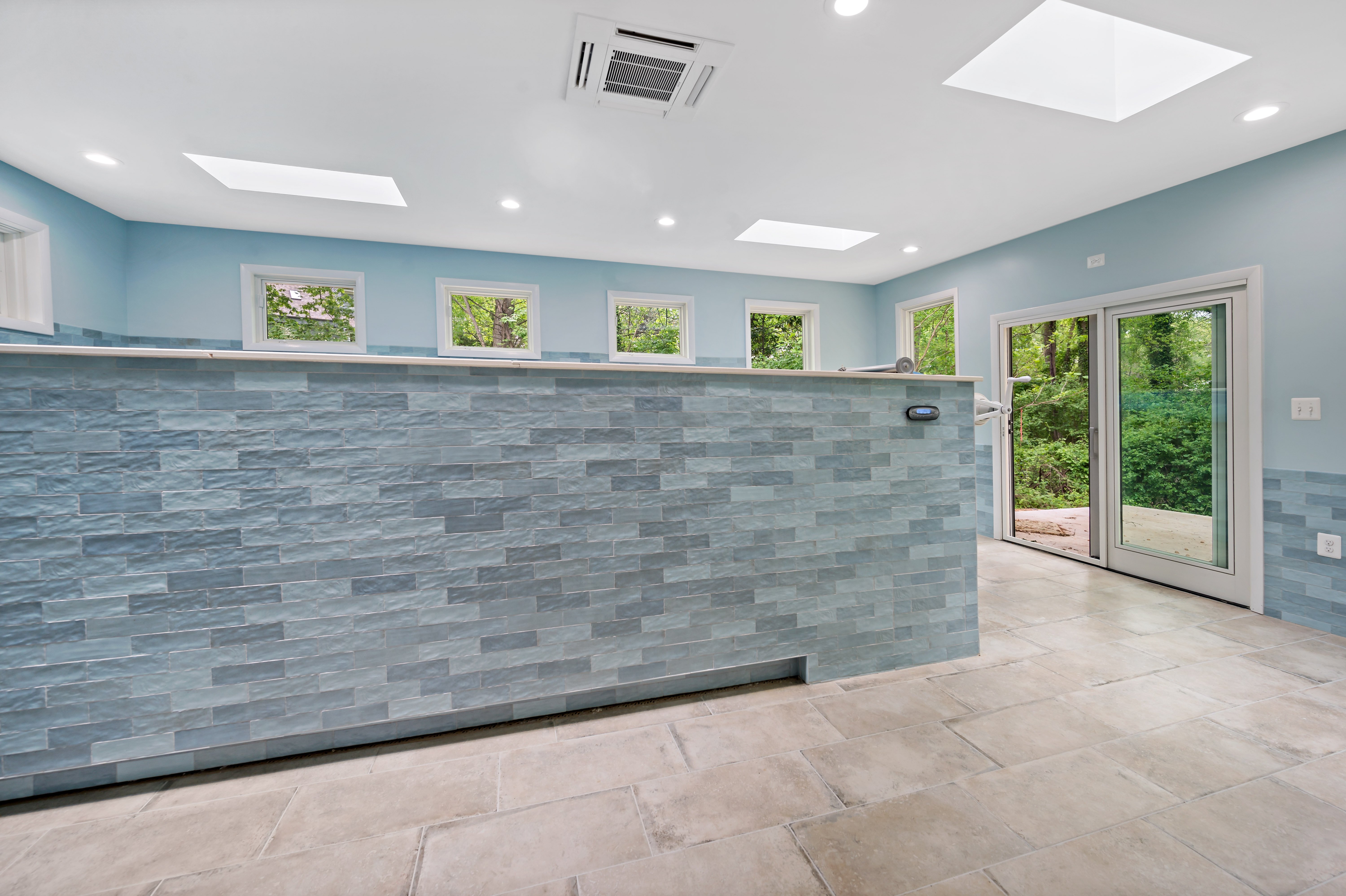 Beige floor tile surrounding indoor pool