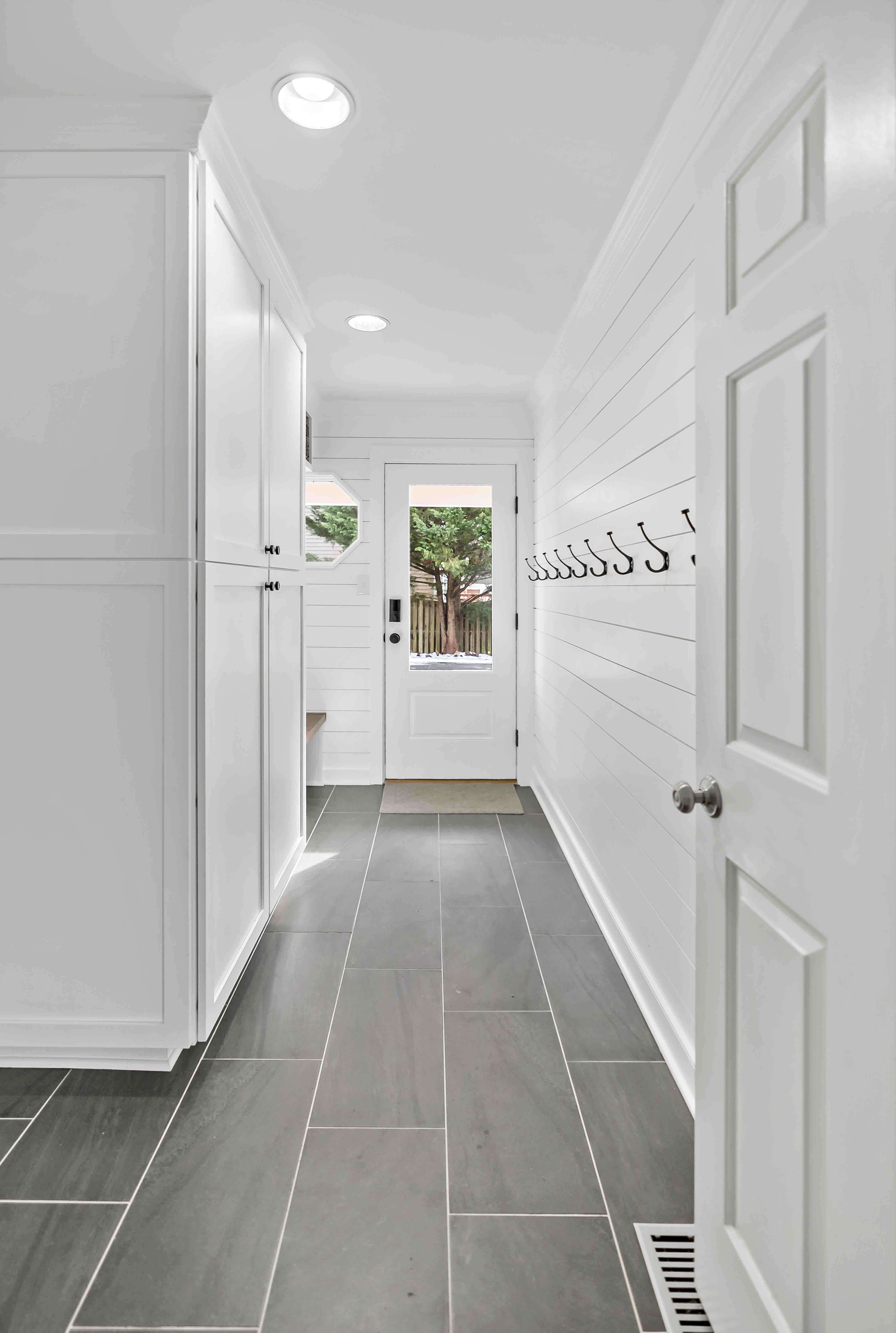 Dark floor tile hallway in mudroom