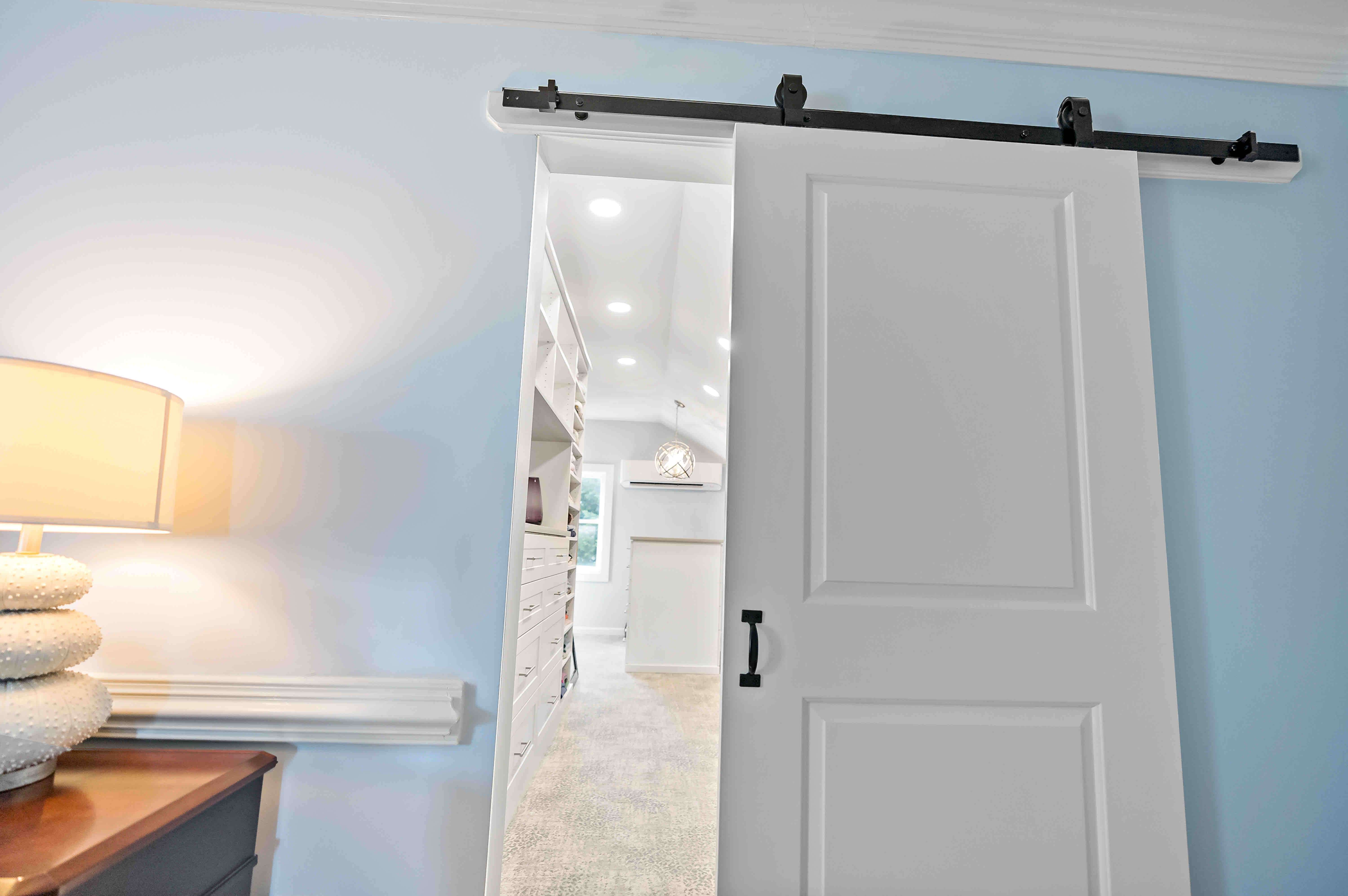 White sliding barn door in bedroom