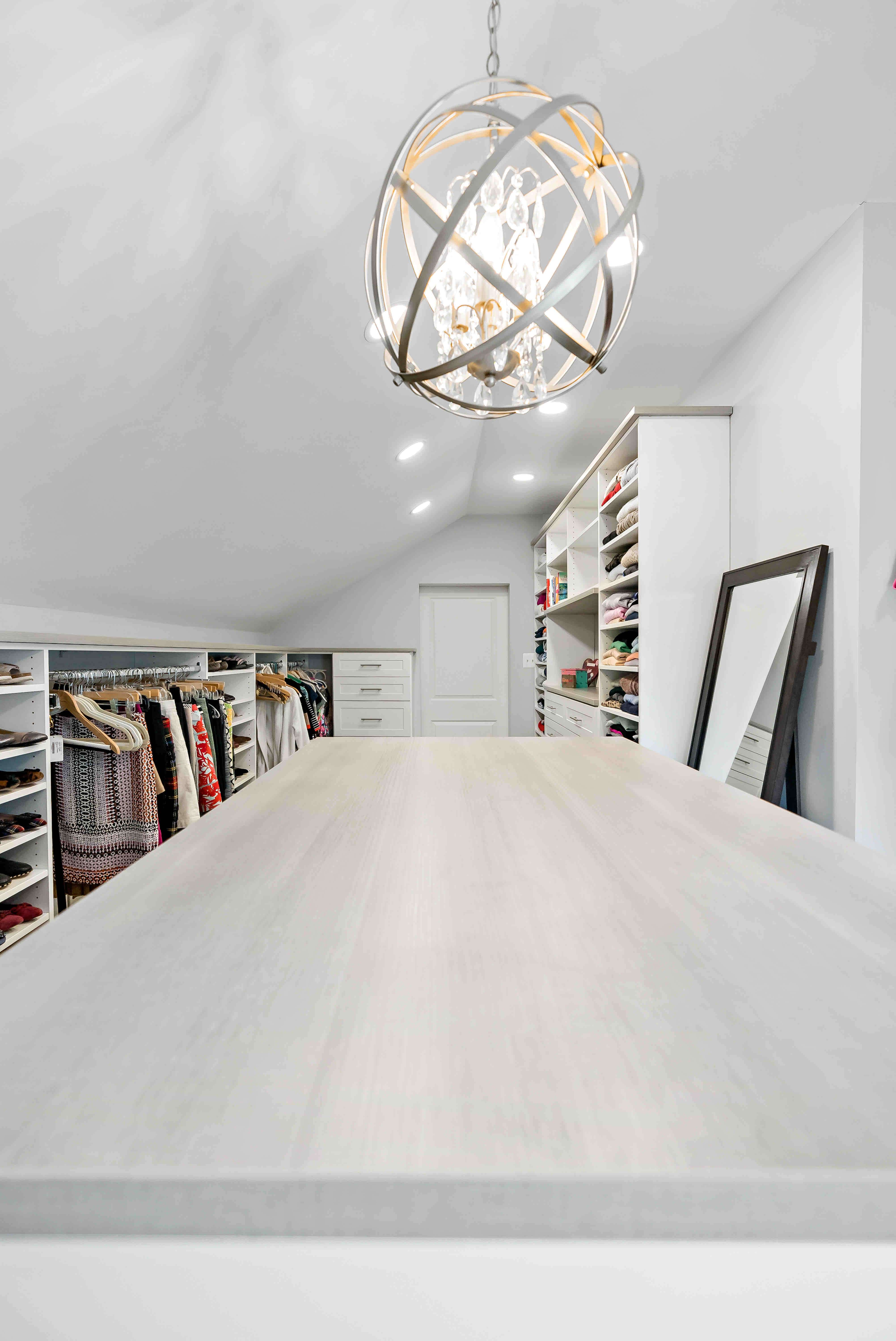 Round chandelier with slanted ceiling in closet