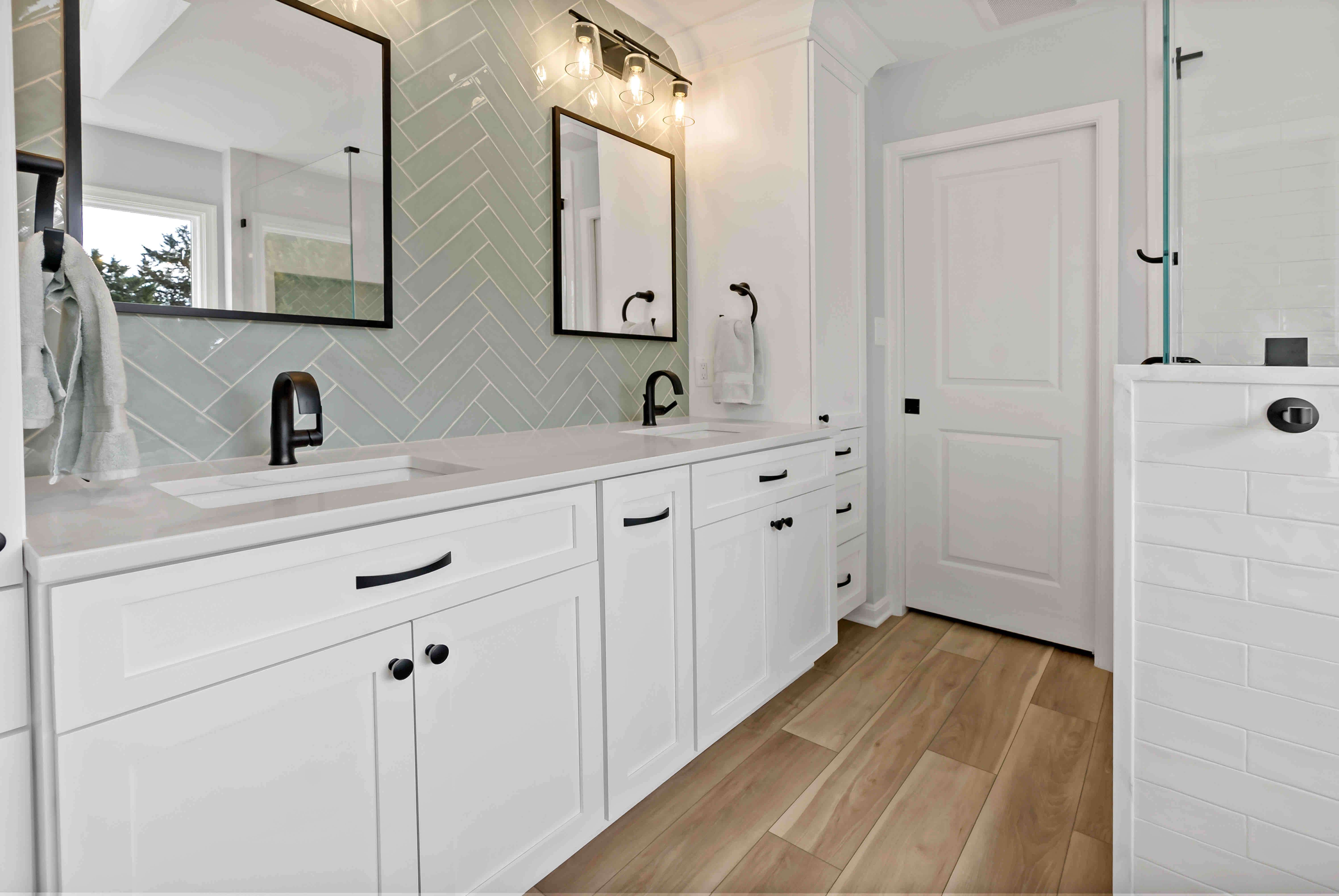 Hard wood floors and white cabinets in bathroom
