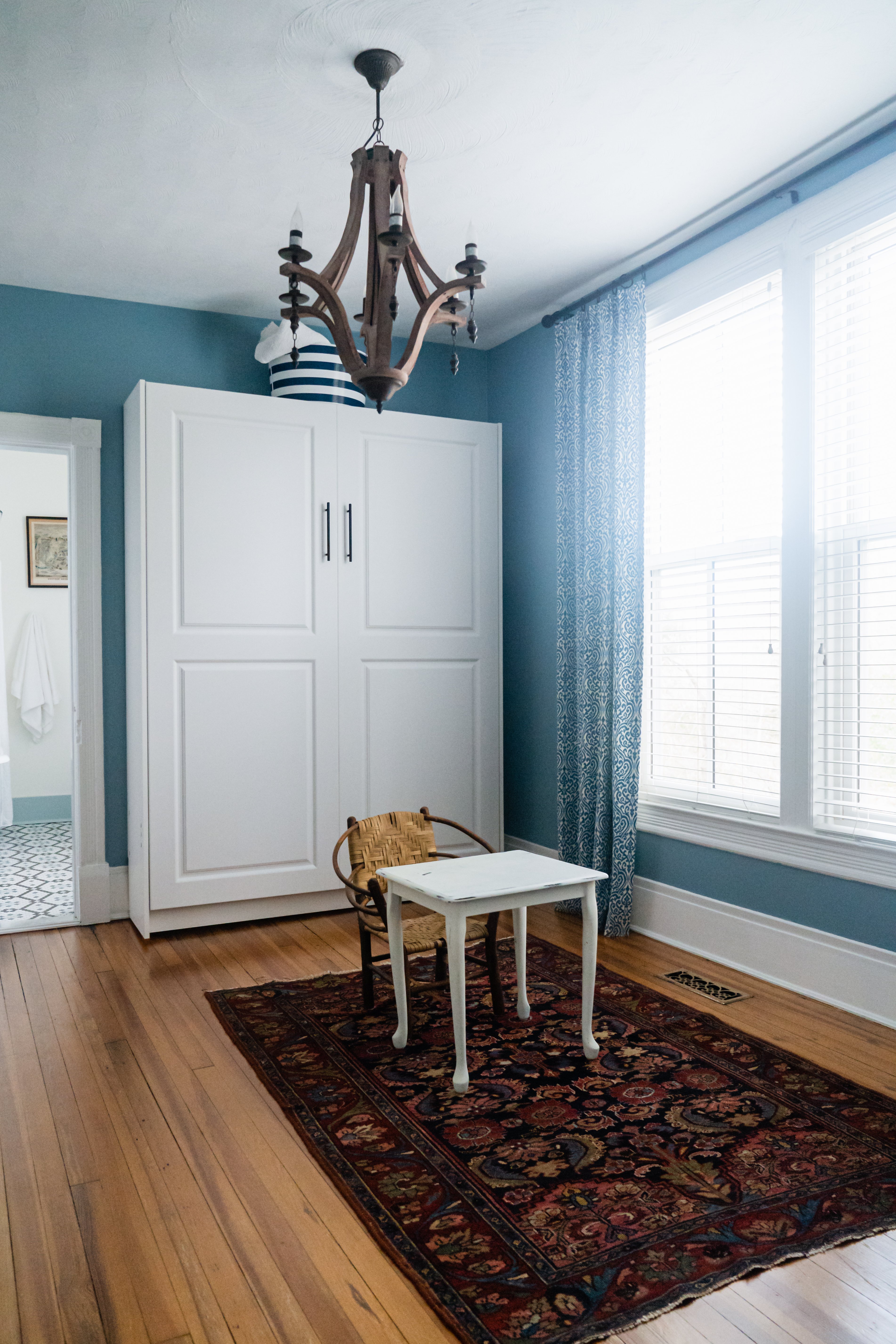 Blue walls and hard wood floors in room
