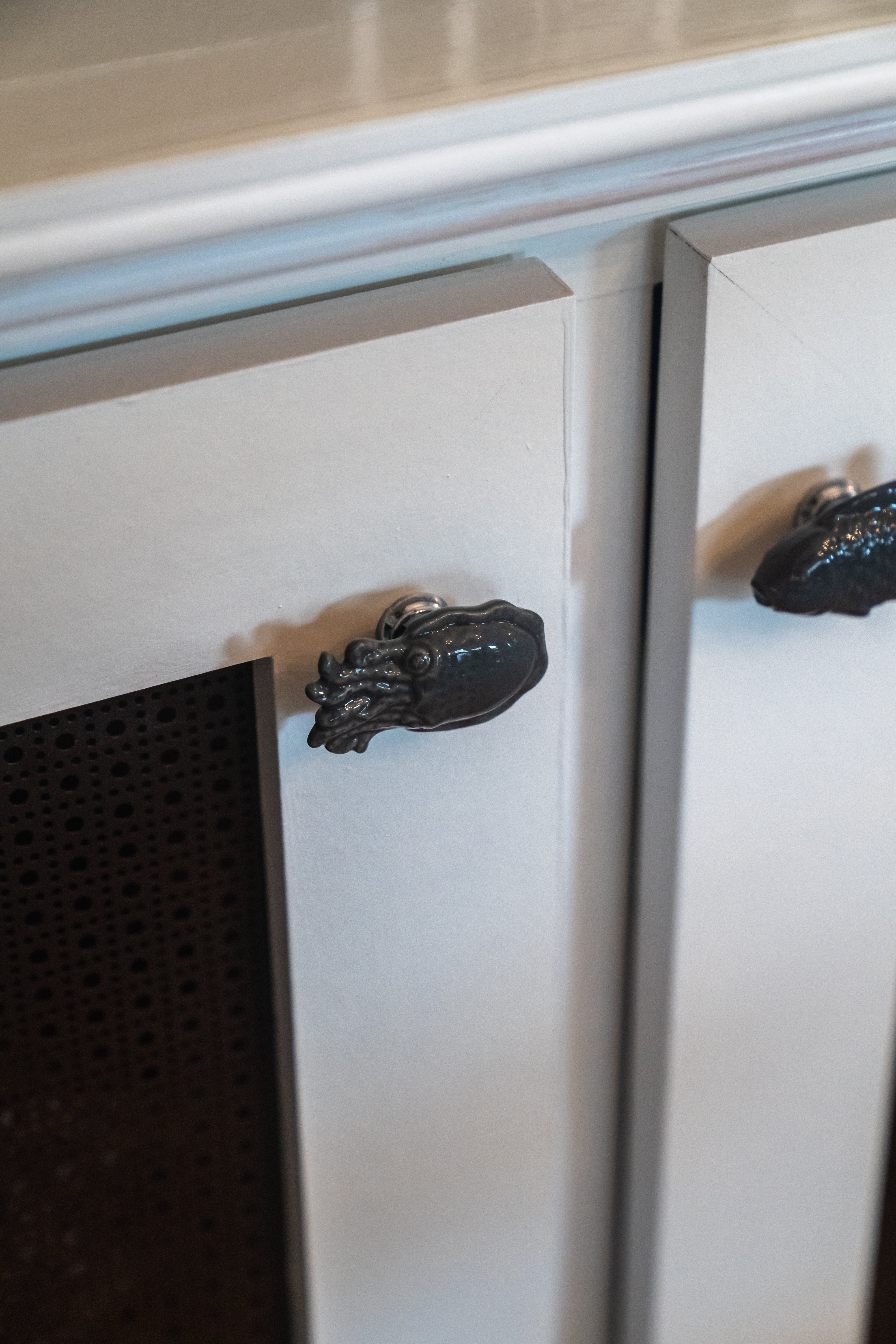 Black fish handle fixtures on cabinets