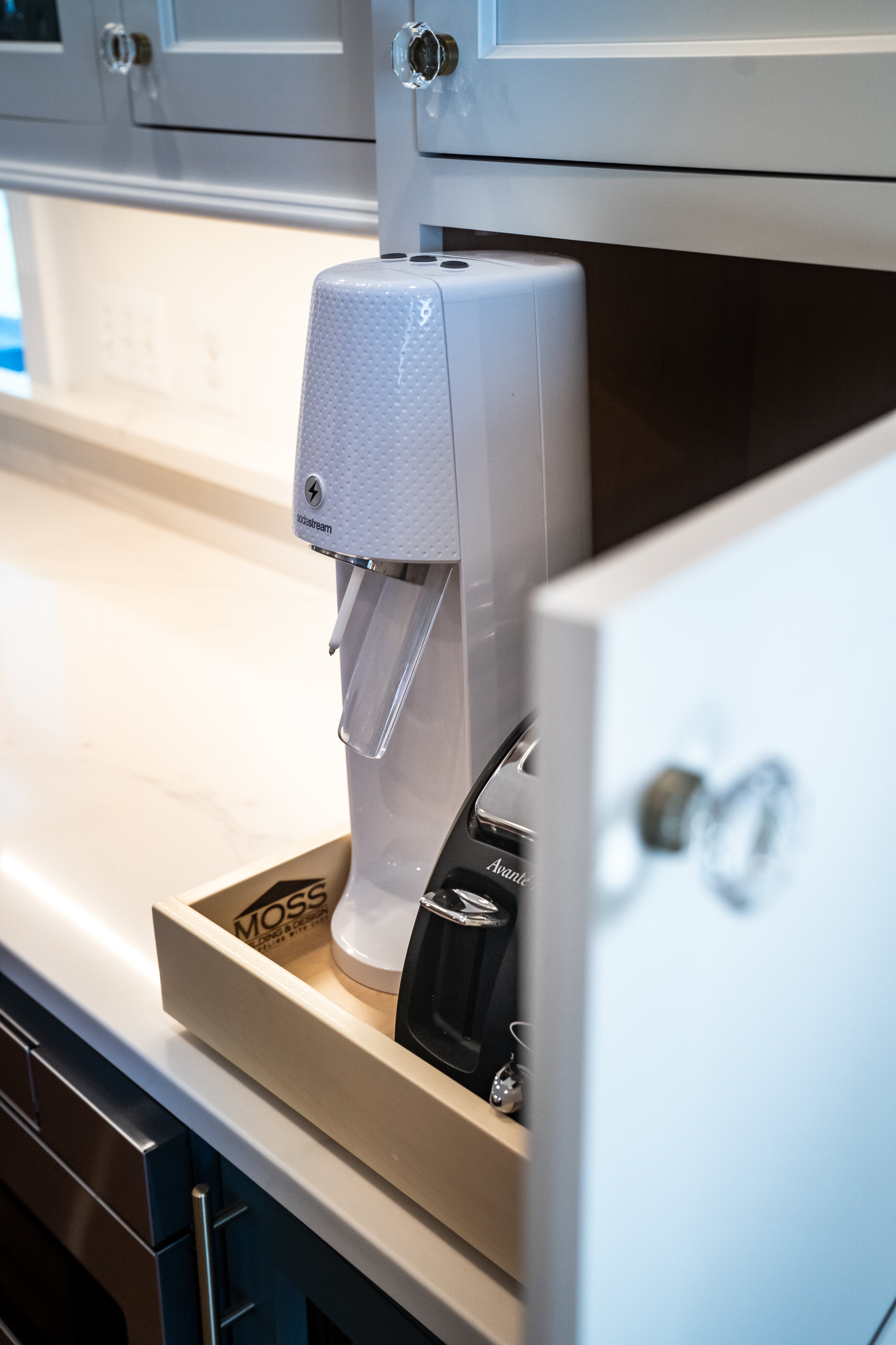 Pull-out drawer in white cabinet