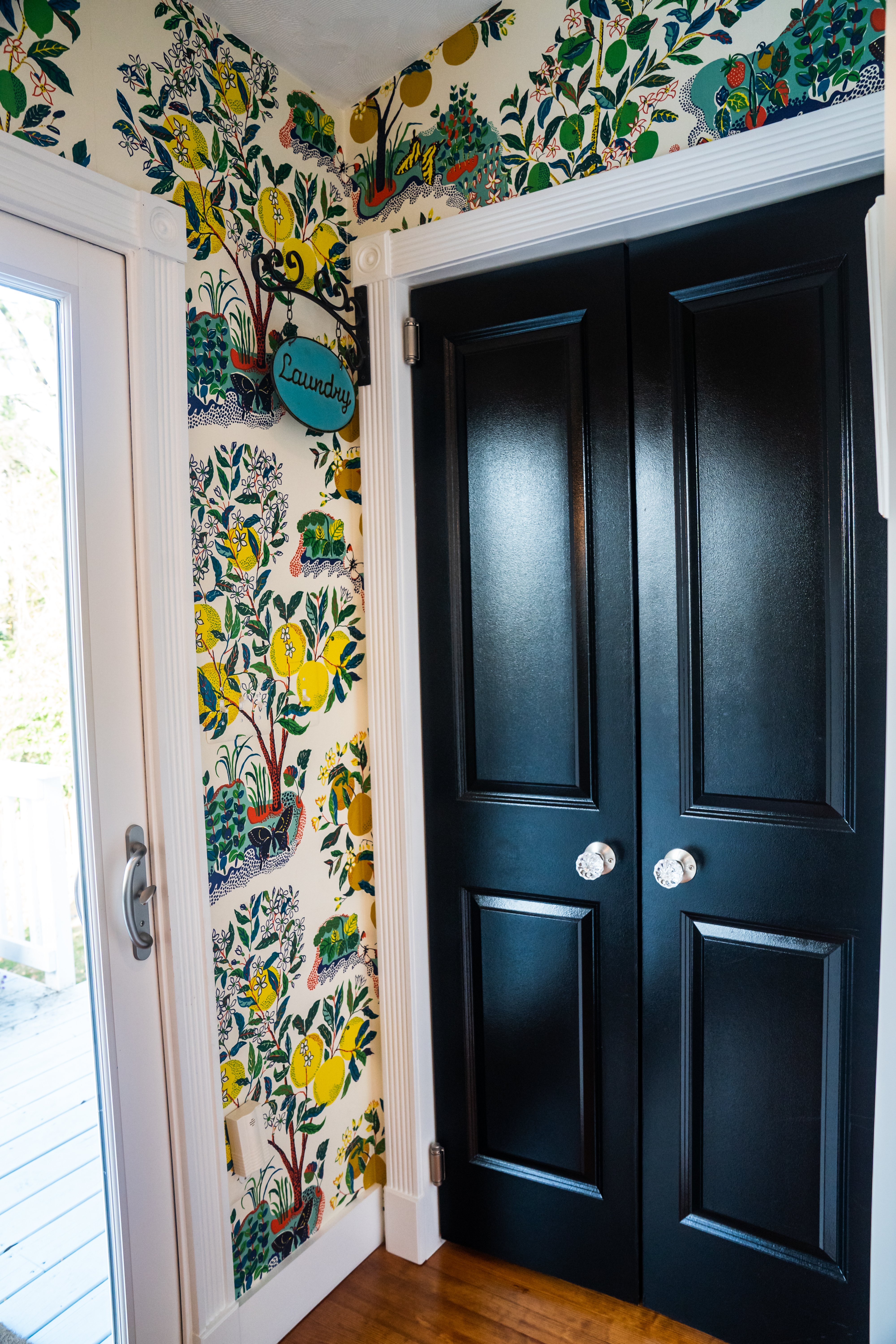 Green wallpaper around door and closet