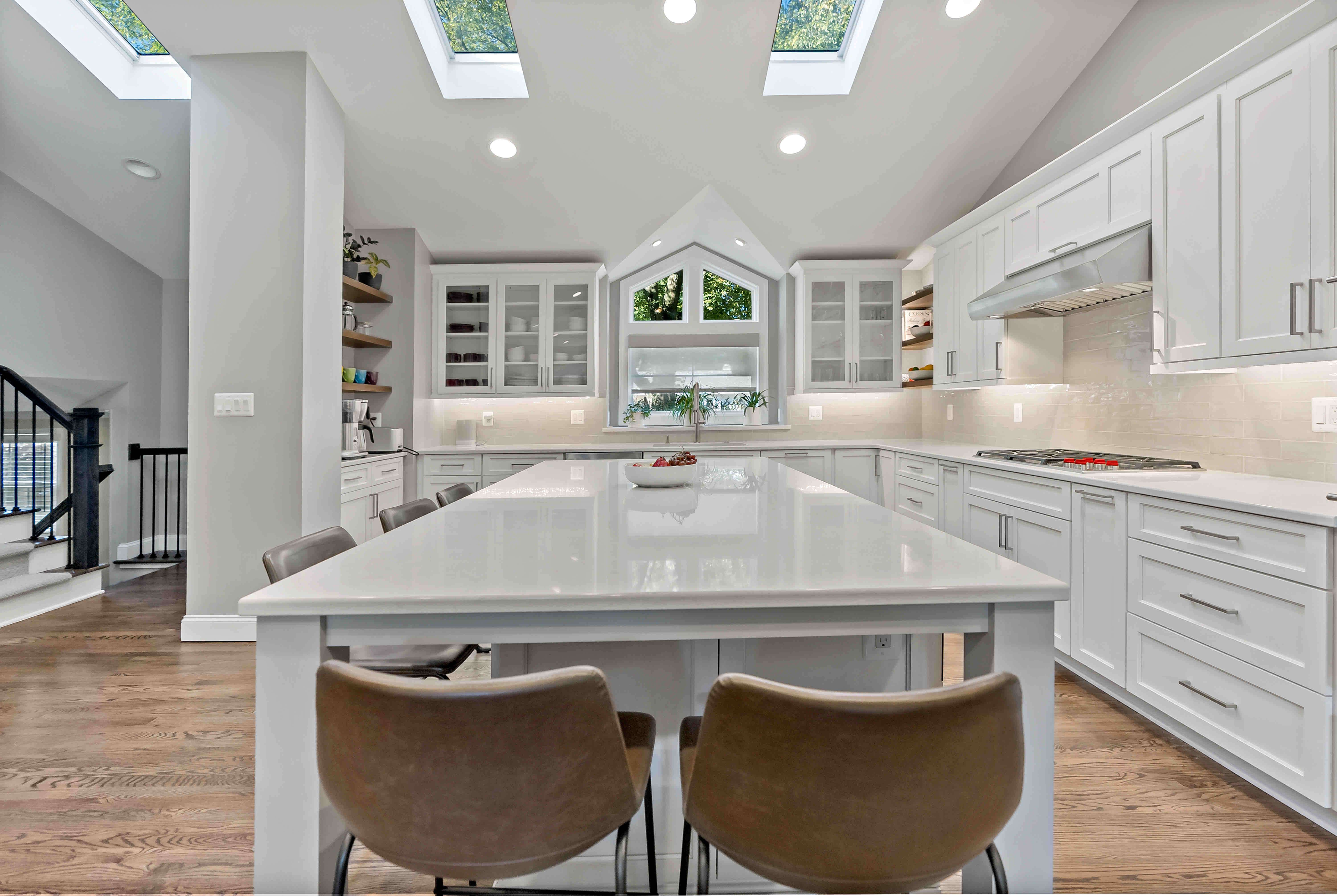 Large island seating and white cabinetry in kitchen