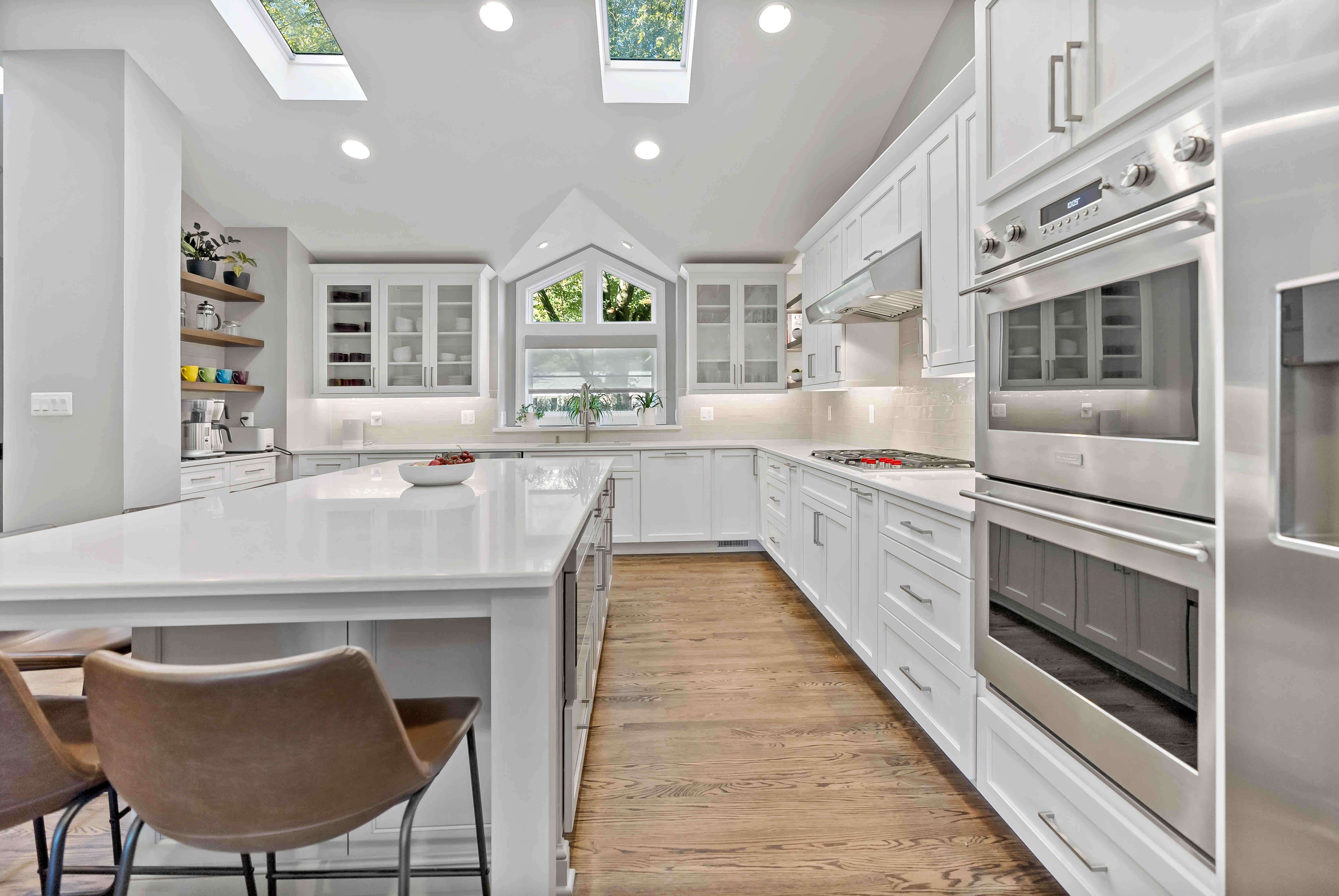 White countertops and cabinets in kitchen with hard wood floors