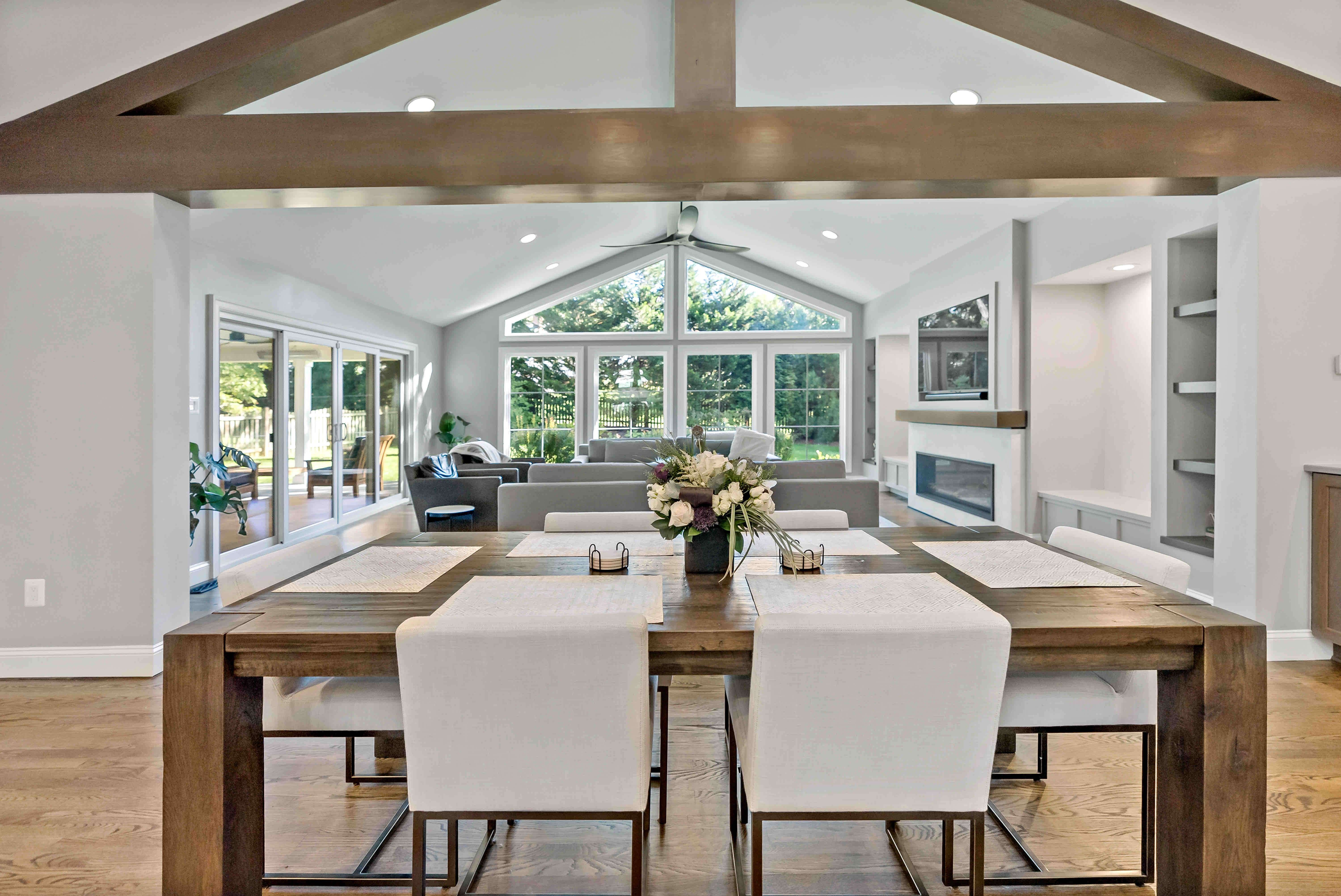 Modern wood dining room table overlooking living room