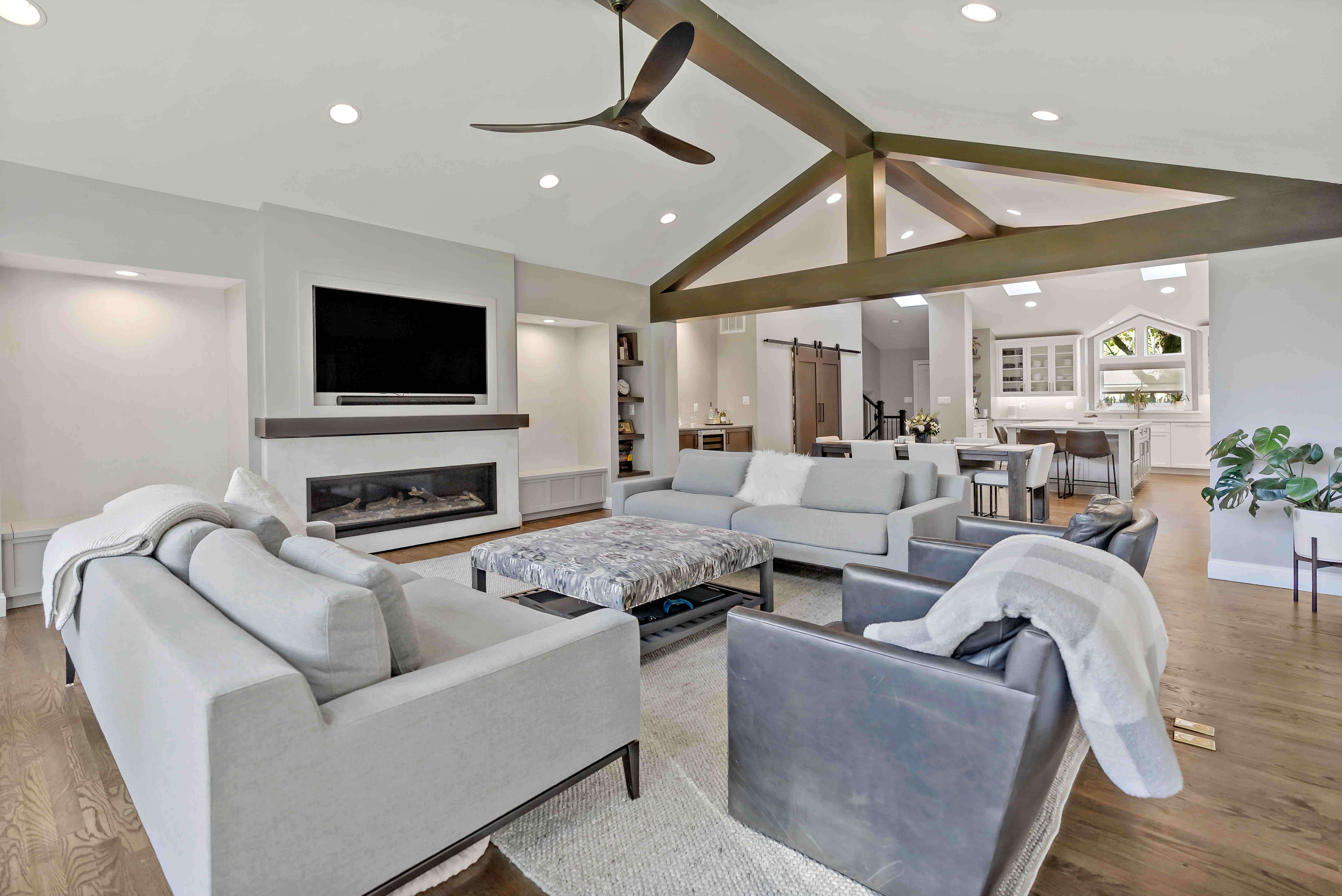 Exposed wooden beams on cathedral ceiling in living room