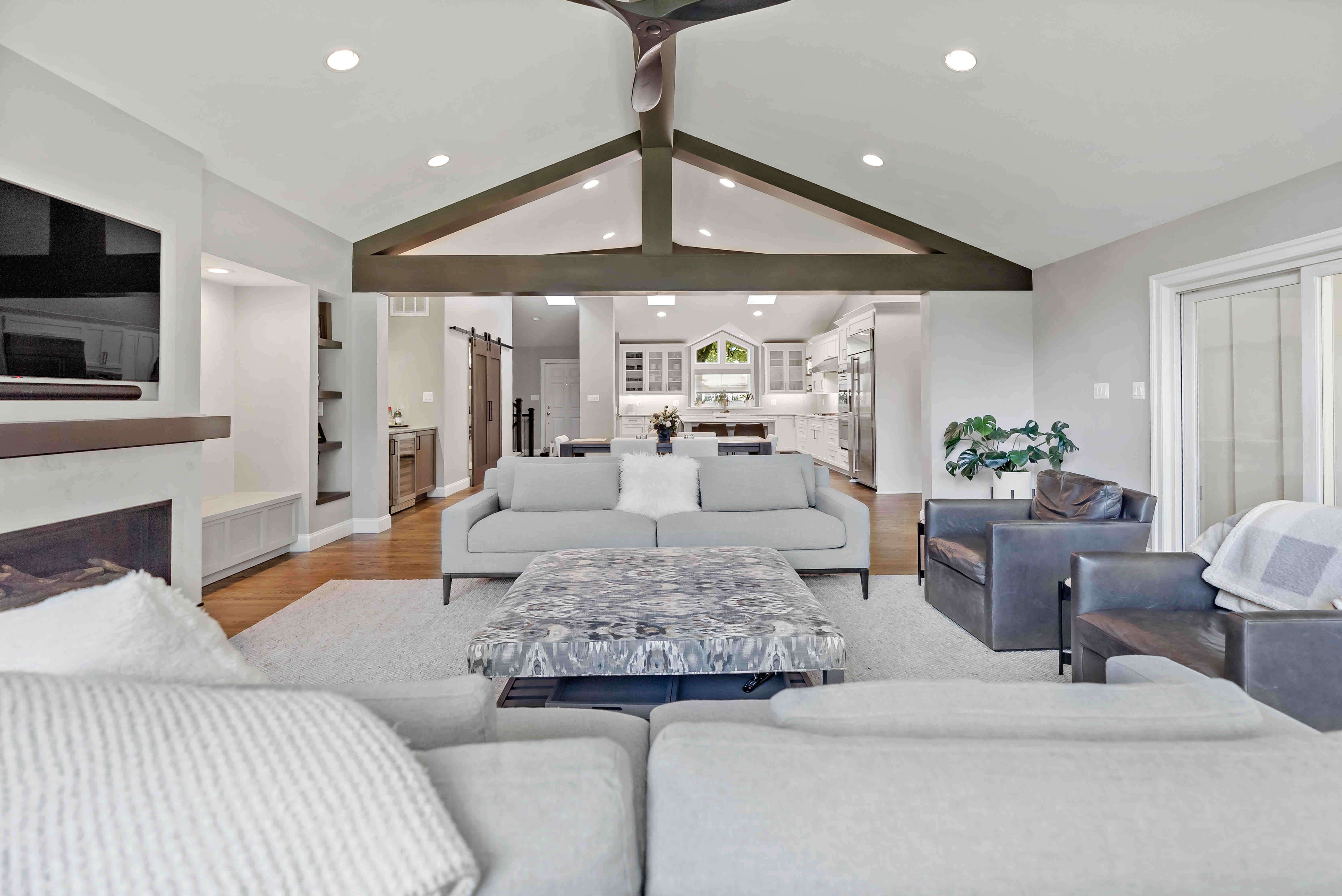 White living room with kitchen view