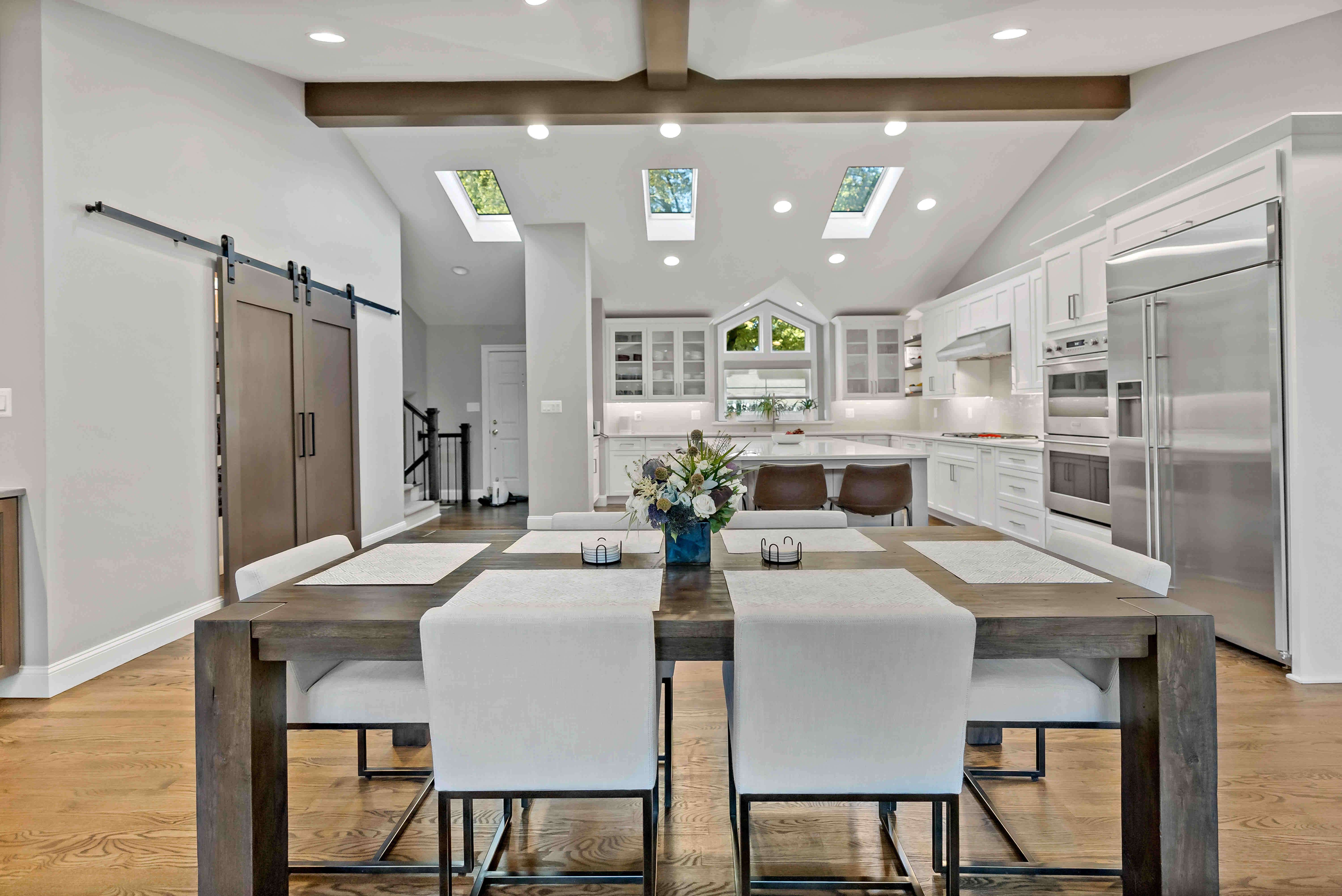 Exposed wood beams on ceiling and wooden dining room table