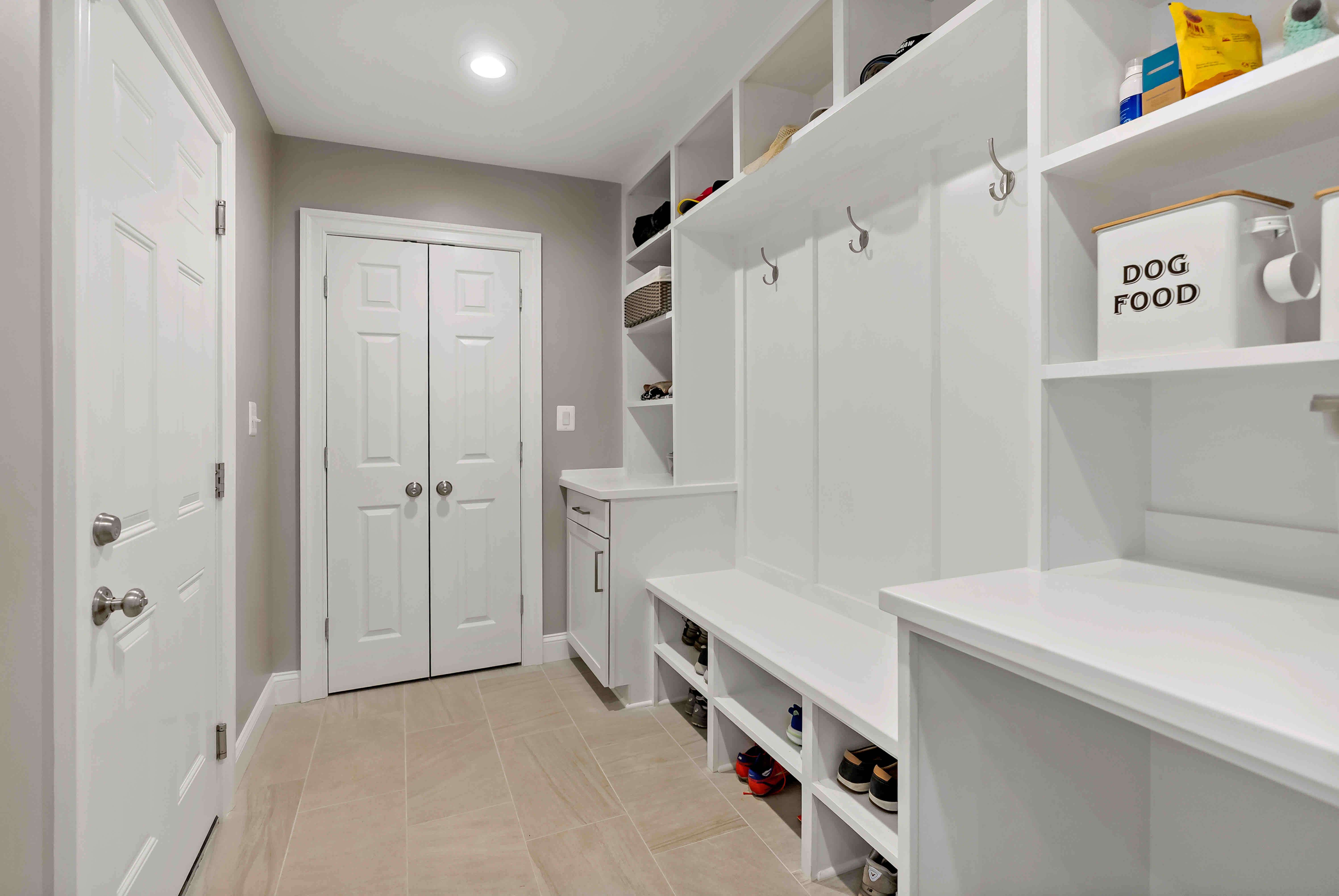 White mudroom with hooks and shelves