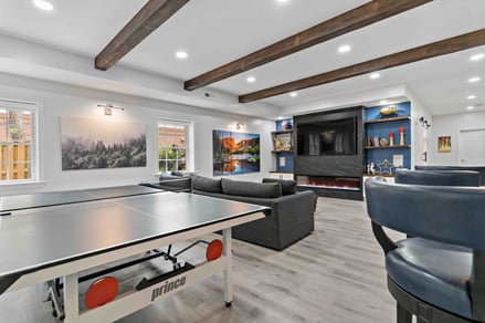 Built-in shelves and electric fireplace in entertainment center for basement