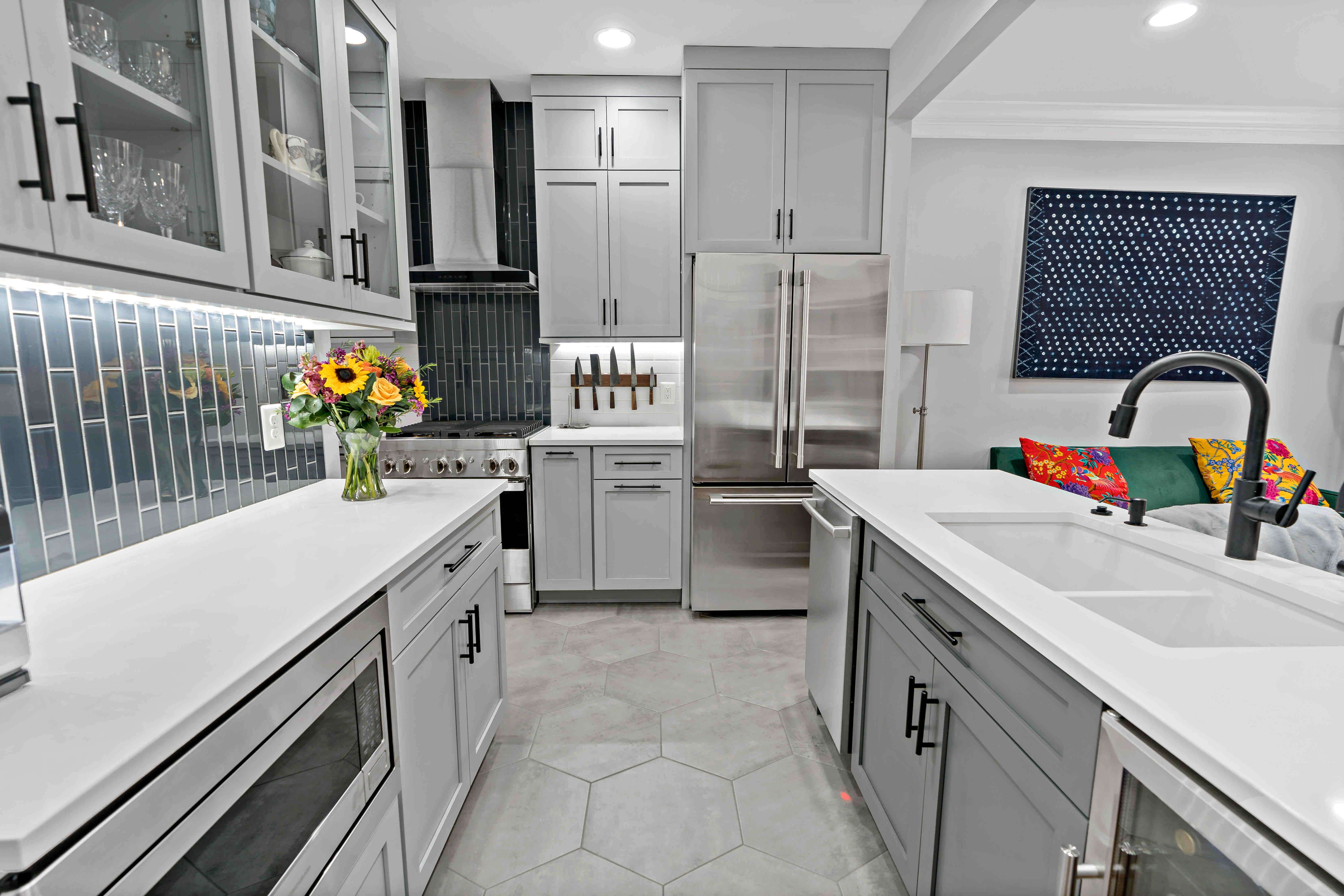 Small kitchen with white countertops and grey cabinetry