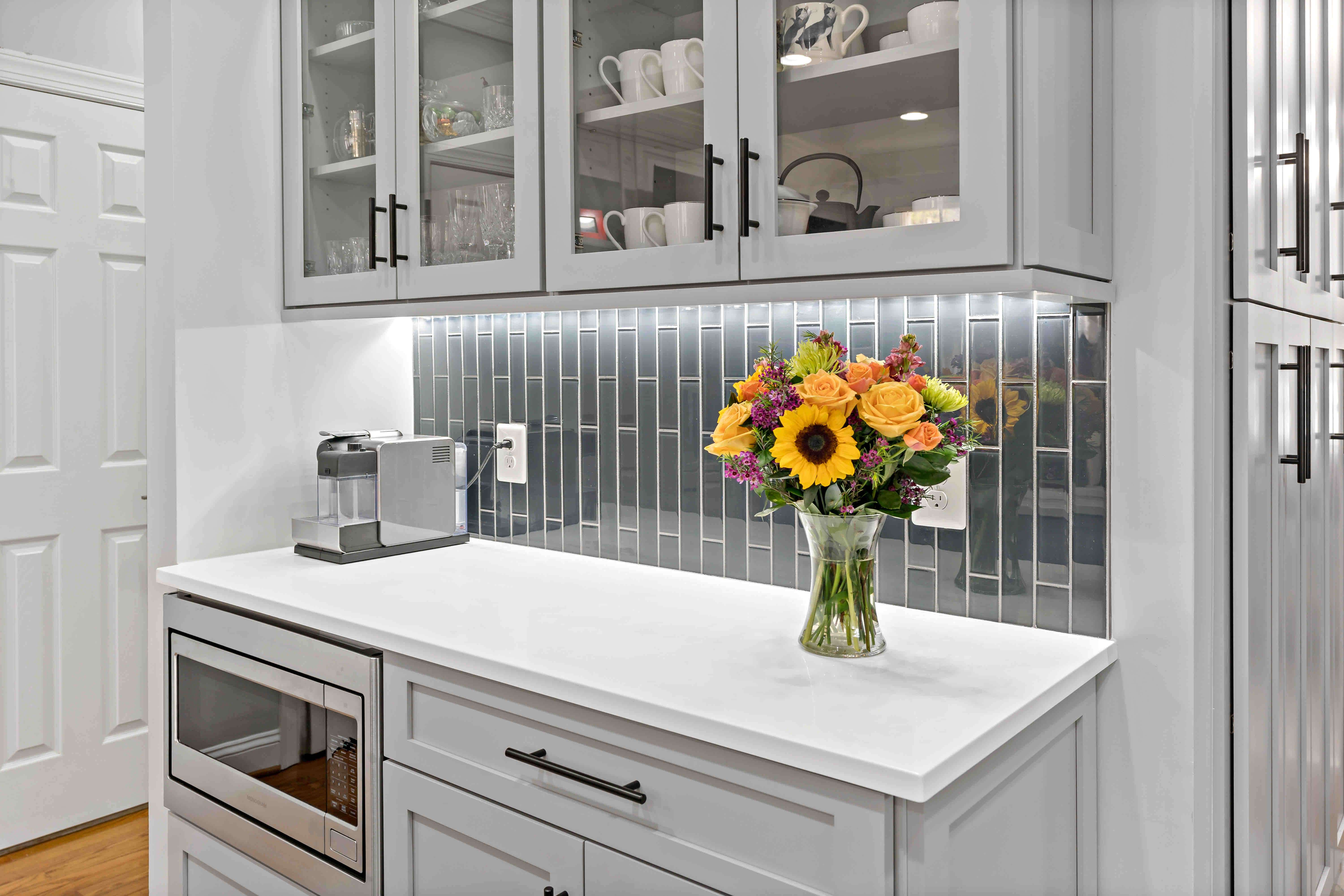 China cabinet with dark grey backsplash underneath