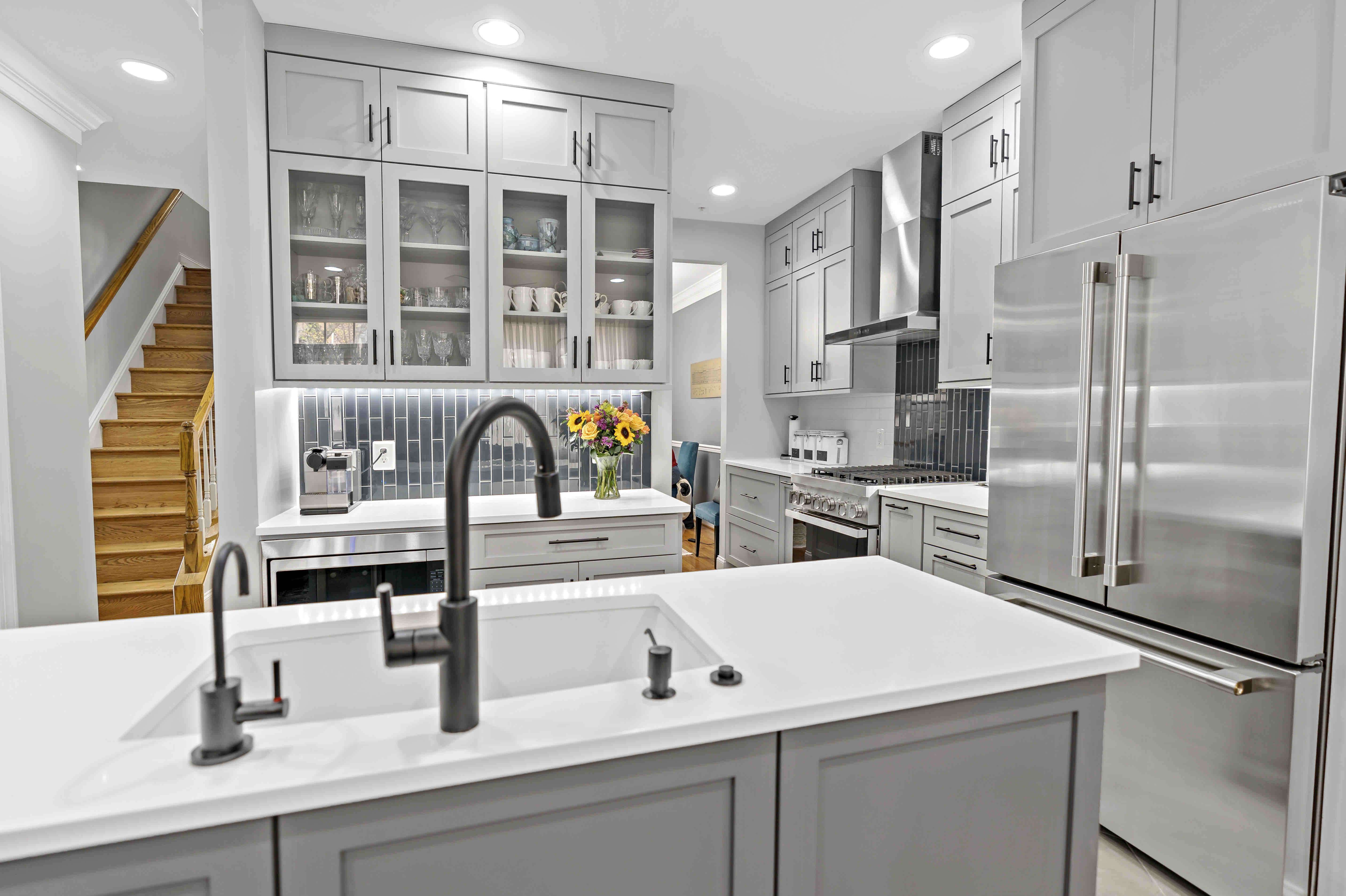 White and grey kitchen with silver appliances