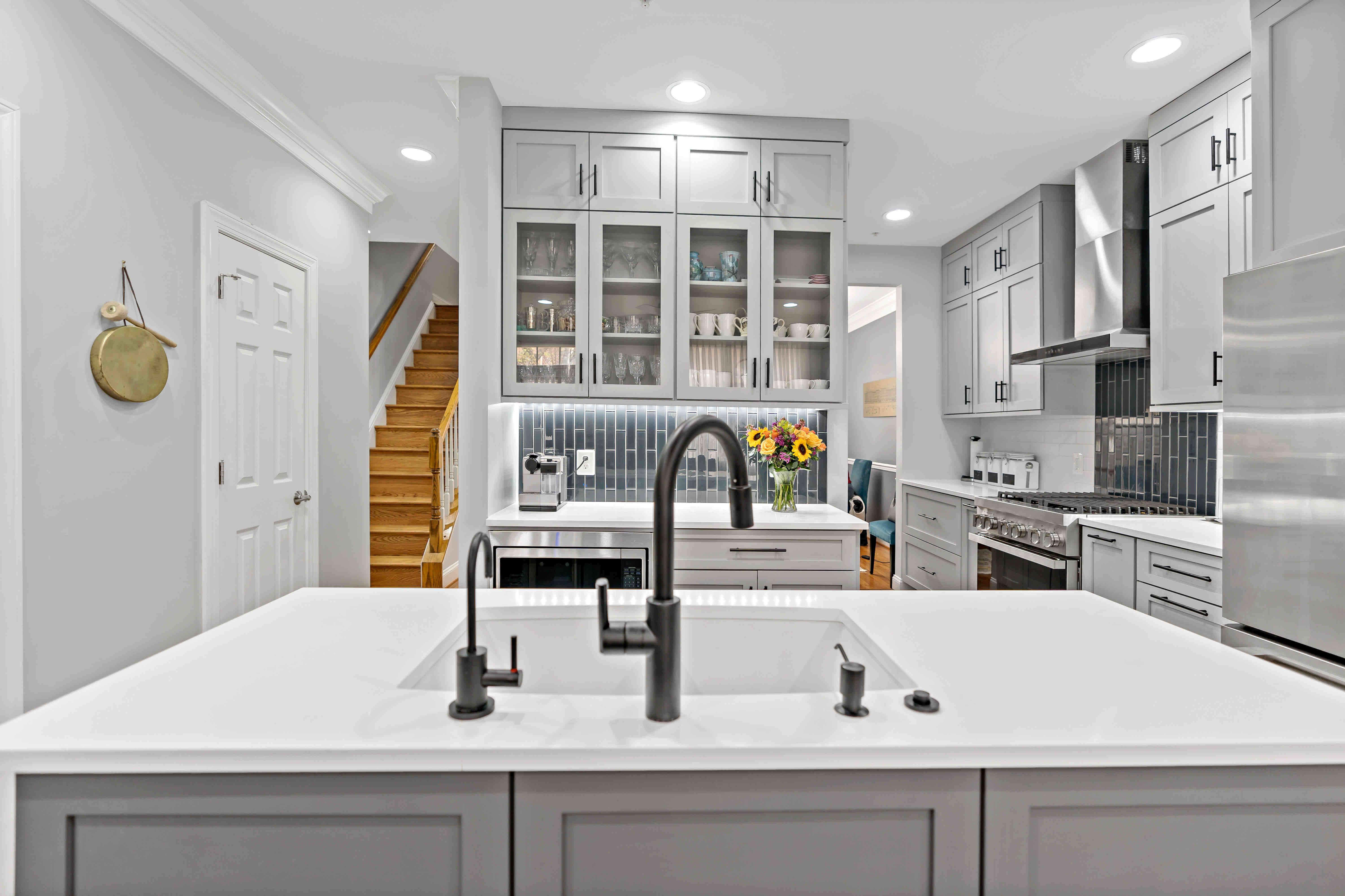 Silver and white kitchen with sink on island
