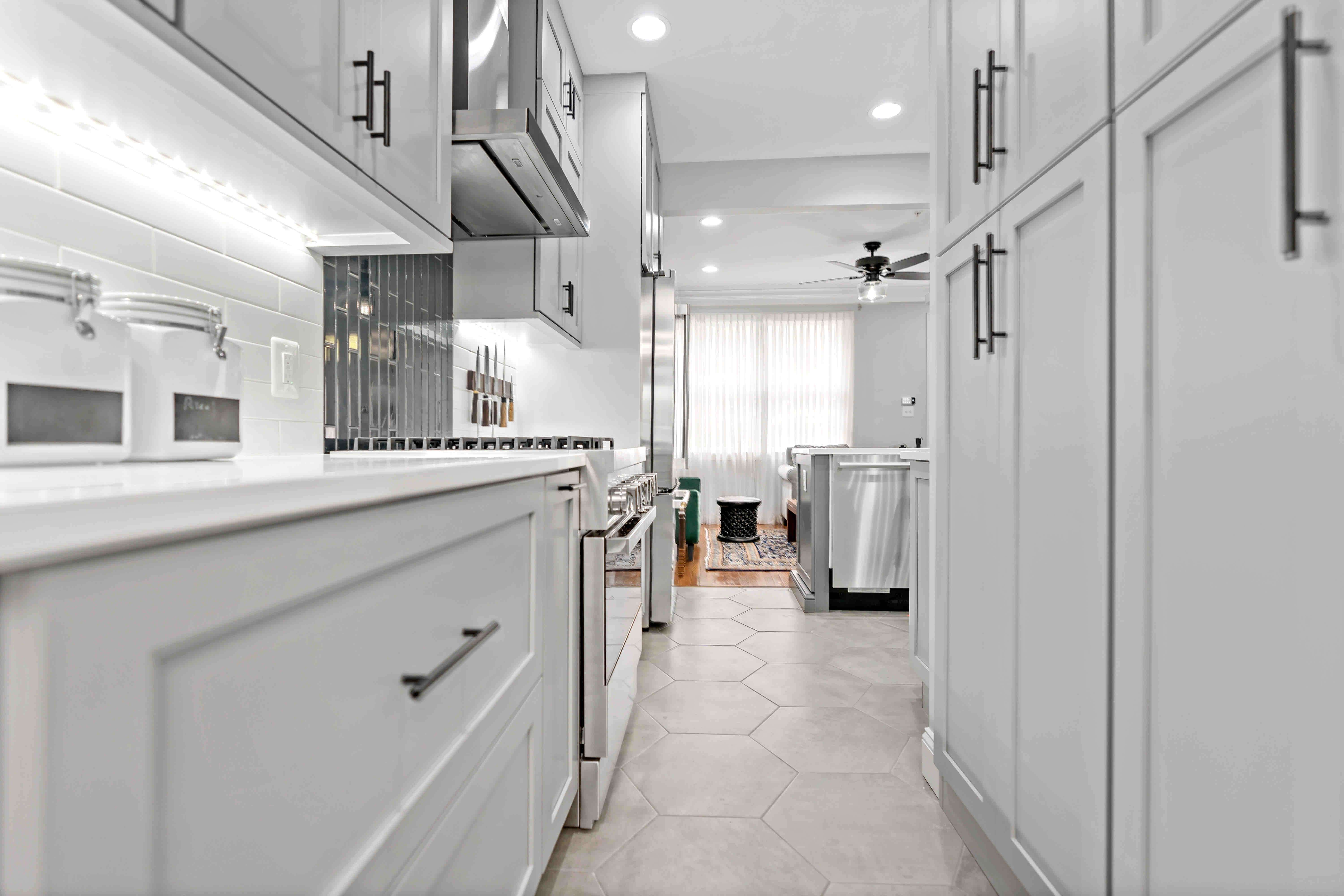 Light grey cabinets with dark grey handles in kitchen