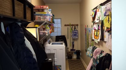 unorganized laundry space before remodel