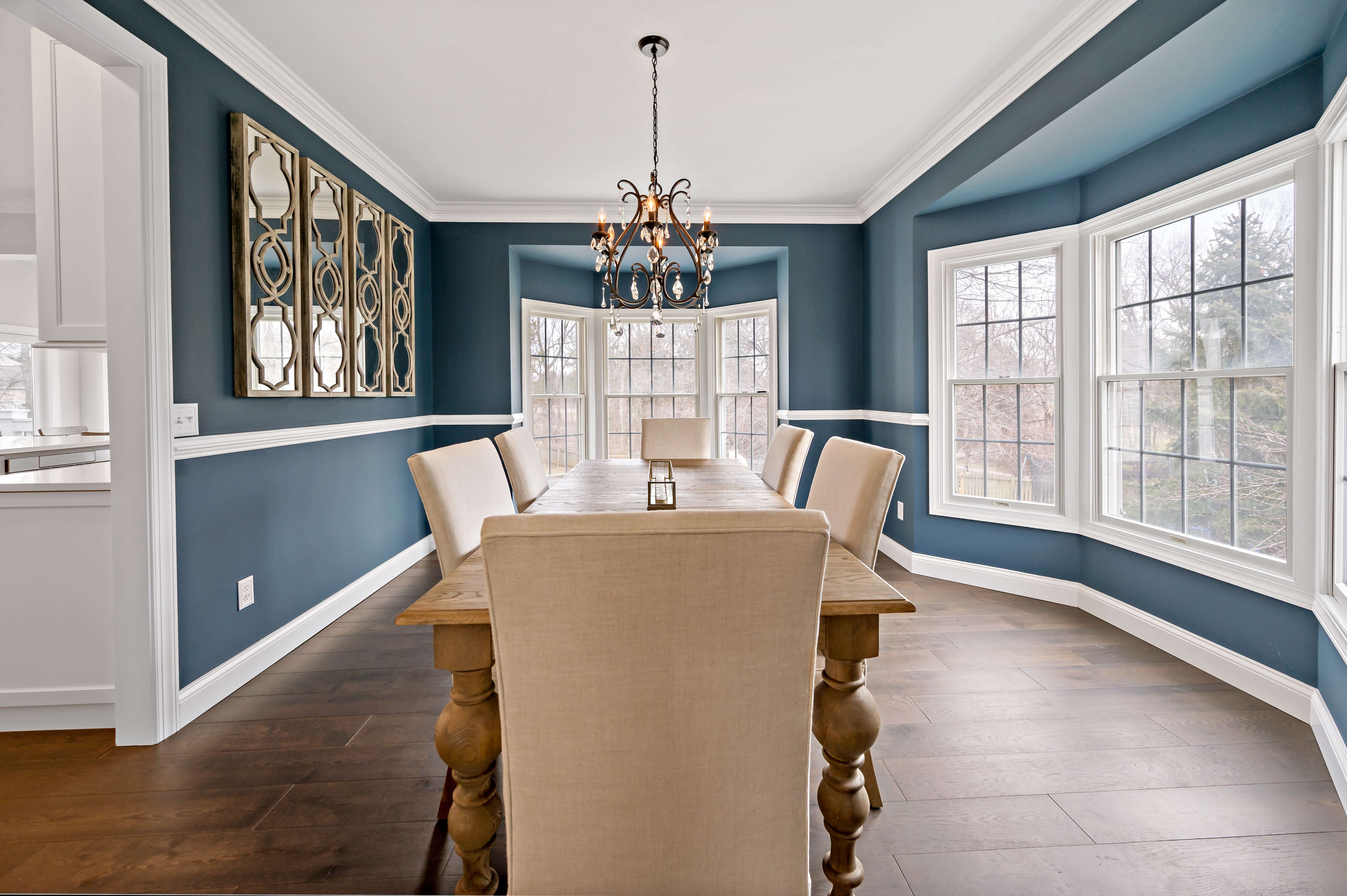Dining room with blue walls and white trim